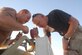 Tech. Sgt. William Phillips, left, an aircraft structrual maintenance specialist, and Staff Sgt. Steven Tsaffarides, a metals technologist, mount a lighted "follow me" sign to a vehicle used to tow aircraft, called a tug. The two Airmen stepped up to assist the transient alert section and mounted the sign after the truck used to guide aircraft to parking spots at Bagram broke down. Parking aircraft is crucial at Bagram because of its limited ramp sapce.  Up to 650 transient aircraft transit Bagram each month brining in vital supplies and people to support Operation Enduring Freedom. (US Air Force photo/Maj. David Kurle)  