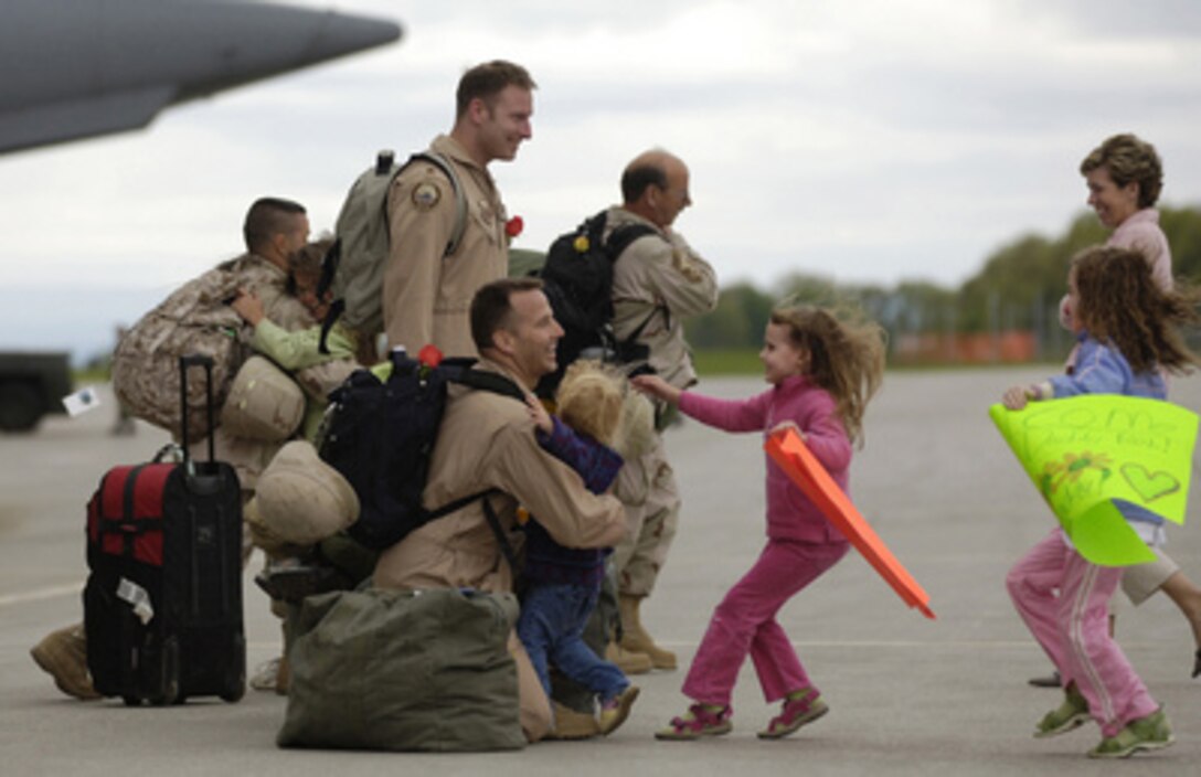 U.S. Air Force Lt. Col. Robert Ammon's children run to him as he arrives in South Burlington, Vt., on May 22, 2006. Ammon is returning after deploying to Iraq. 