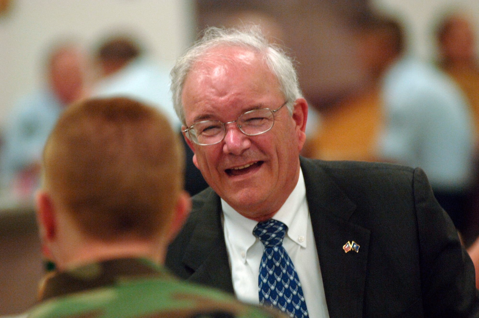 Secretary of the Air Force Michael W. Wynne talks to Airman Basic Bradley Cline at lunch at Lackland Air Force Base, Texas, on Friday, June 2, 2006. Secretary Wynne was in San Antonio visiting various military installations and training sites. Airman Cline is assigned to the 326th Training Squadron. (U.S. Air Force photo/Tech. Sgt. Cecilio M. Ricardo Jr.)