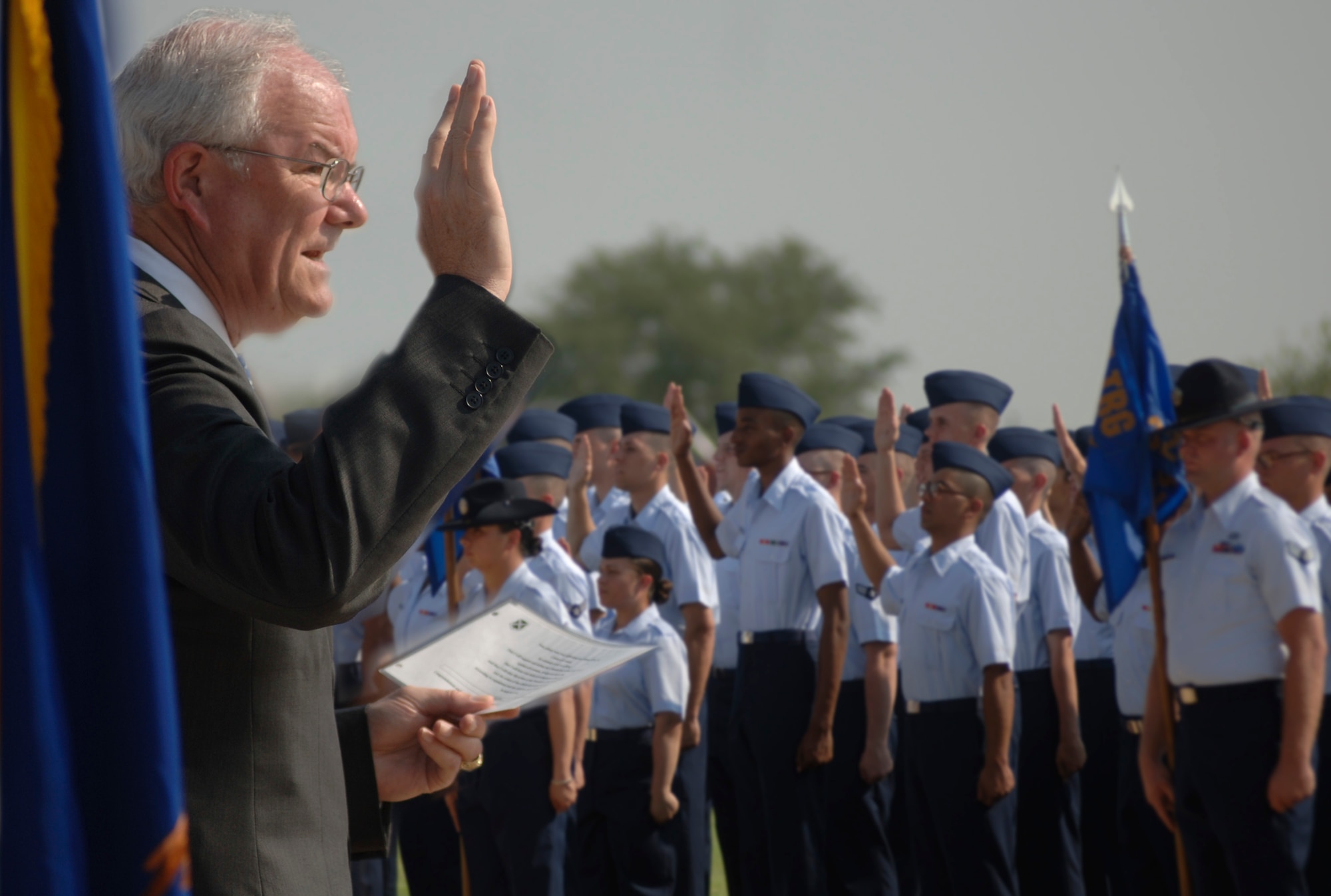 Secretary of the Air Force Michael W. Wynne administers the Oath of Enlistment to basic training graduates on the parade grounds at Lackland Air Force Base, Texas, on Friday, June 2, 2006. Secretary Wynne was in San Antonio visiting various military installations and training sites. (U.S. Air Force photo/Tech. Sgt. Cecilio M. Ricardo Jr.)