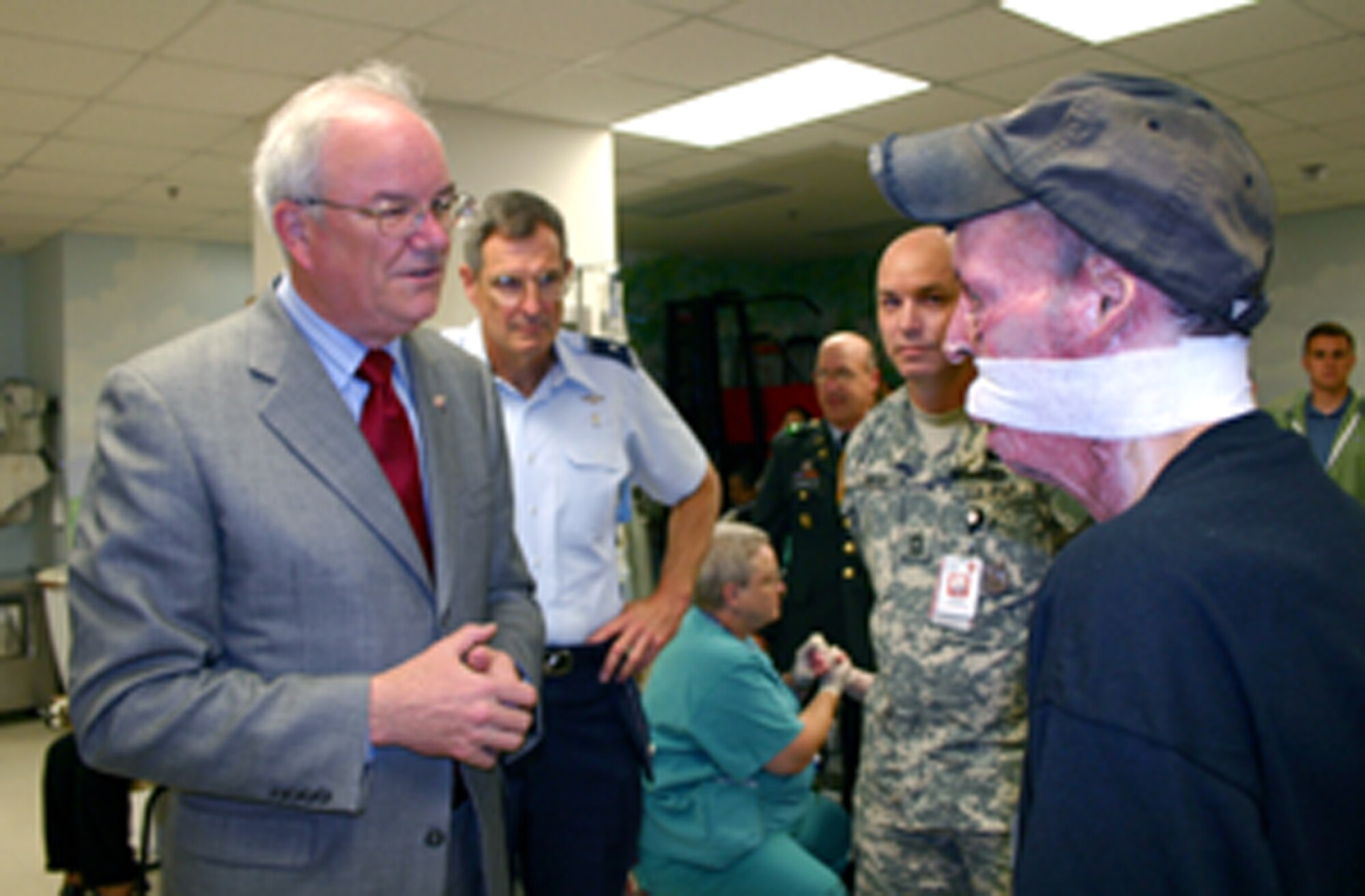 (From left) Secretary of the Air Force Michael W. Wynne, Brig. Gen. (Dr.) David G. Young III and Army Master Sgt. Ben Martin visit with Staff Sgt. Israel Del Toro Jr. at Brooke Army Medical Center in San Antonio on Thursday, June 1, 2006. Sergeant Del Toro, a tactical air control party operator, was injured in combat in December 2004 while supporting Operation Enduring Freedom in Afghanistan. Secretary Wynne was in San Antonio visiting various military installations and training sites. General Young is commander of the 59th Medical Wing at Lackland Air Force Base and Sergeant Martin is assigned to BAMC. (U.S. Air Force photo/2nd Lt. David Herndon)