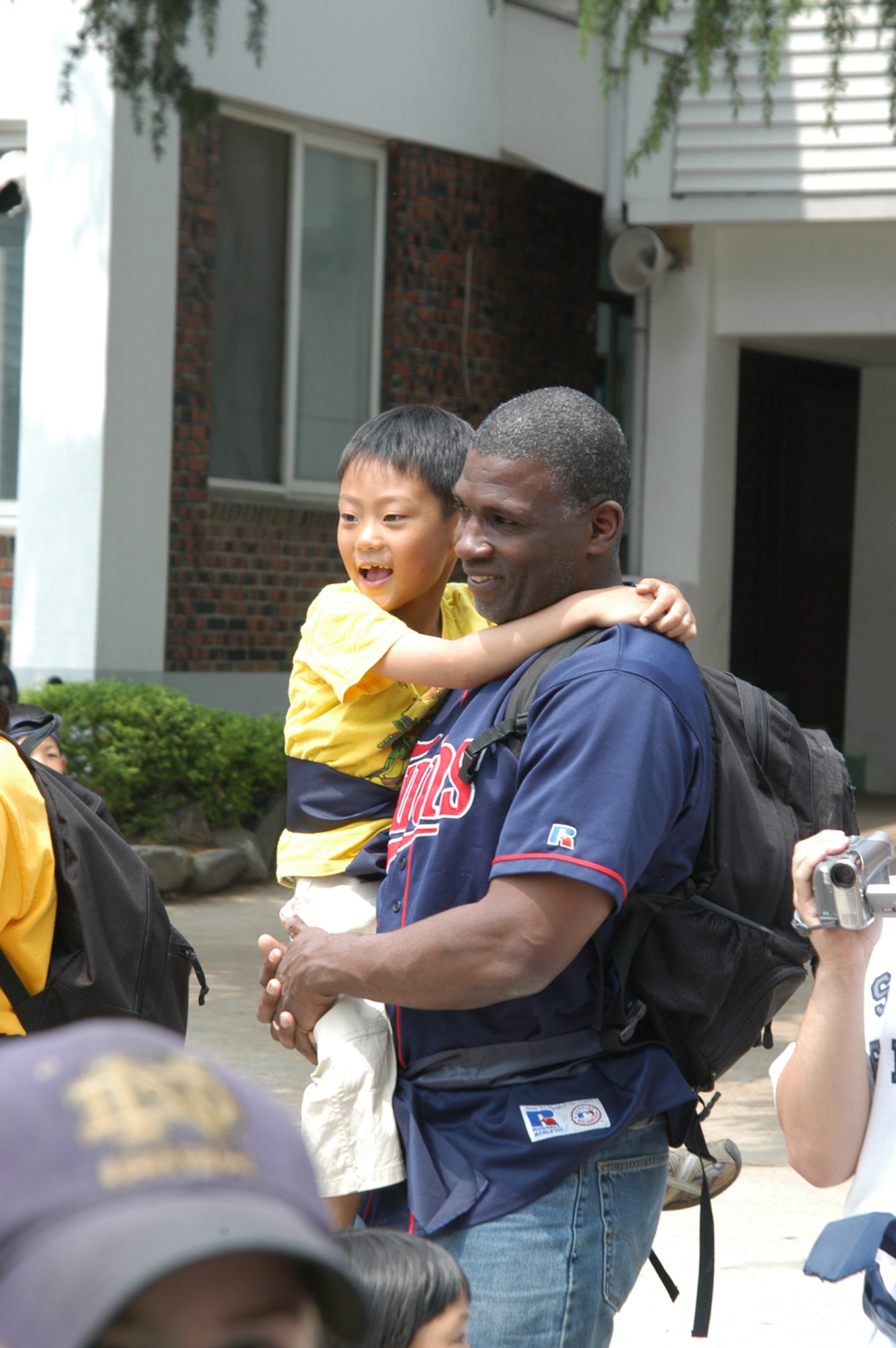 KUNSAN AIR BASE, Republic of Korea - Lt. Col. Jeffrey Hunt, 8th Security Forces Squadron commander, makes a new friend May 20 before the tee ball game. (Air Force photo by Senior Airman Stephen Collier)                                