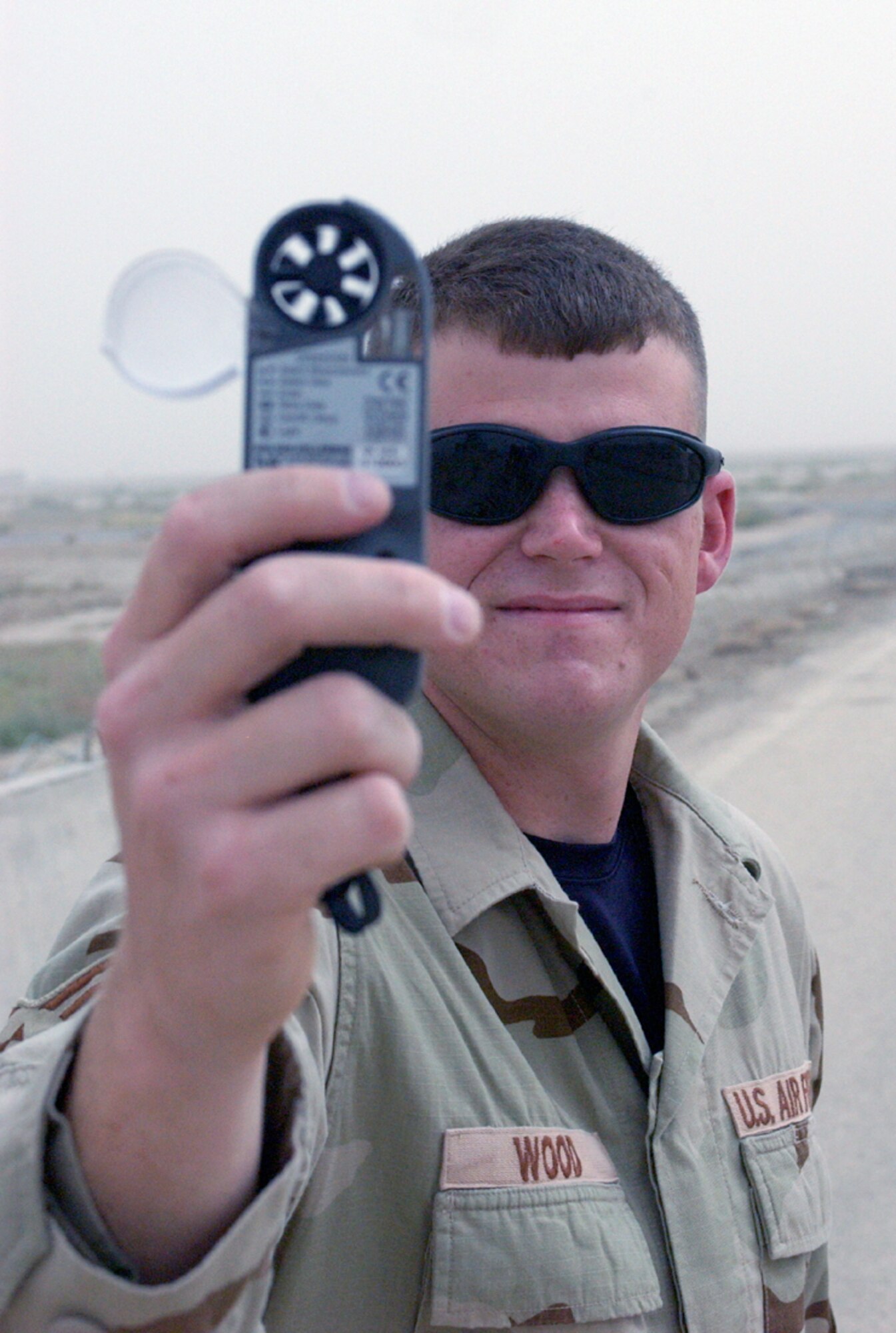 Staff Sgt. Aaron Wood checks wind speed and direction with a portable monitor at Ali Base, Iraq, on Tuesday, May 30, 2006. Forecasters need to know the wind speeds and directions to give pilots accurate information on arrivals and departures. Sergeant Wood is with the 407th Expeditionary Operations Support Squadron and is deployed from Eglin Air Force Base, Fla. (U.S. Air Force photo/Master Sgt. Andrew Gates)
