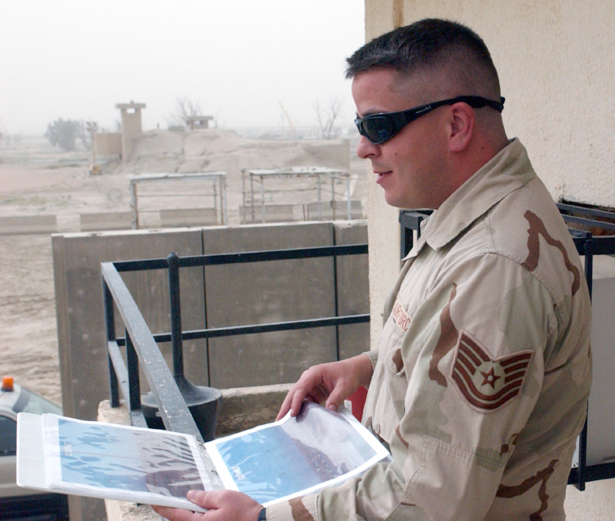 Tech. Sgt. Jared Ey checks visibility during a dust storm at Ali Base, Iraq, on Tuesday, May 30, 2006. Sergeant Ey is with the 407th Expeditionary Operations Support Squadron and is deployed from Hickam Air Force Base, Hawaii. (U.S. Air Force photo/Master Sgt. Andrew Gates)
