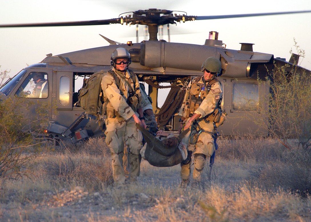 Pararescuemen from the 48th Rescue Squadron at Davis-Monthan Air Force Base, Ariz., transport a simulated patient onto an HH-60 Pave Hawk at Gila Bend Auxiliary Air Field, Ariz., on Tuesday, May 30, 2006. The scenario involved a simulated plane crash with 20 survivors and was part of a major accident response exercise. Pararescuemen were evaluated on their initial on-scene assessment, treatment and response time. (U.S. Air Force photo/Airman 1st Class Veronica Pierce)