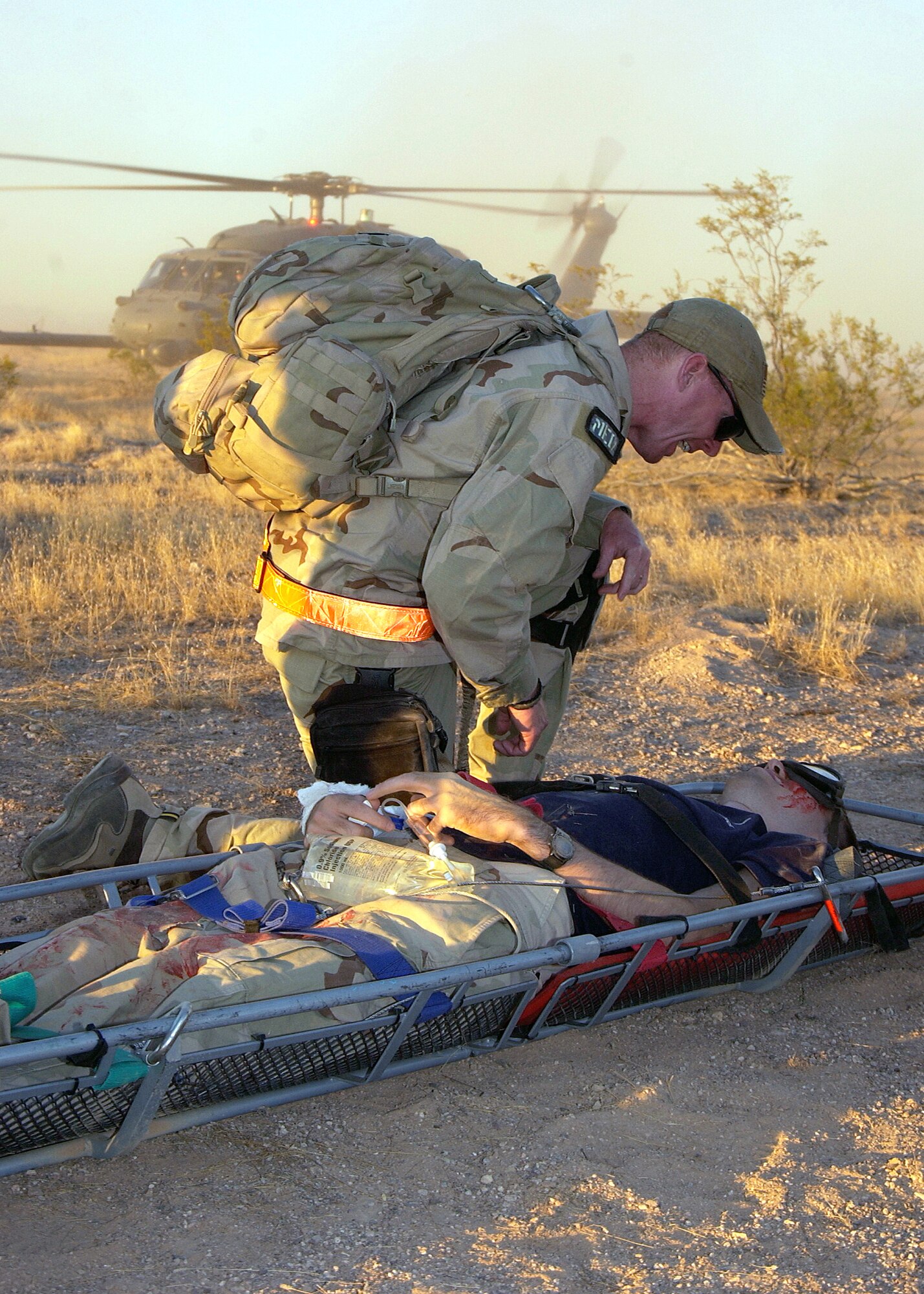 Capt. (Dr.) John Dorch checks the vital signs of a simulated patient before he is transferred to an HH-60 Pave Hawk at Gila Bend Auxiliary Air Field, Ariz., on Tuesday, May 30, 2006. The scenario involved a simulated plane crash with 20 survivors and was part of a major accident response exercise. Pararescuemen were evaluated on their initial on-scene assessment, treatment and response time. Captain Dorch is a flight surgeon with the 48th Rescue Squadron at Davis-Monthan Air Force Base, Ariz. (U.S. Air Force photo/Airman 1st Class Veronica Pierce)
