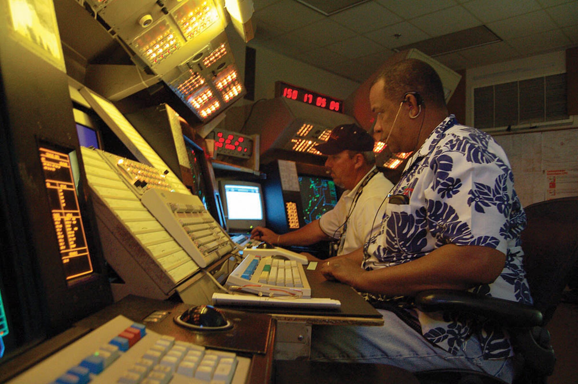 EDWARDS AIR FORCE BASE, Calif. — Tim Bryant (foreground) and John Snyder (back), Radar Control Facility’s Space Positioning Optical Radar Tracking air traffic controllers, provide an extra set of “eyes” for the pilots performing test missions. SPORT controllers inform aircrew members of the location, altitude and direction of other aircraft in close proximity as well as air space boundary notifications and weather and airport information. (Air Force photo by Airman 1st Class Julius Delos Reyes)