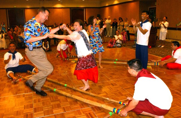 Col. Steve Arquiette, 60th Air Mobility Wing commander, performs the Tinikling, the Philippines’ national dance, with Carrie Basaca, Travis Youth Center school age coordinator, during the Asian Pacific American Heritage Banquet May 30. The Tinikling is a fast rhythmic dance that mimics the movements of the “tikling” birds in the rice fields in their effort to avoid being clipped with the bamboo traps. (U.S. Air Force photo by Nan Wylie)





