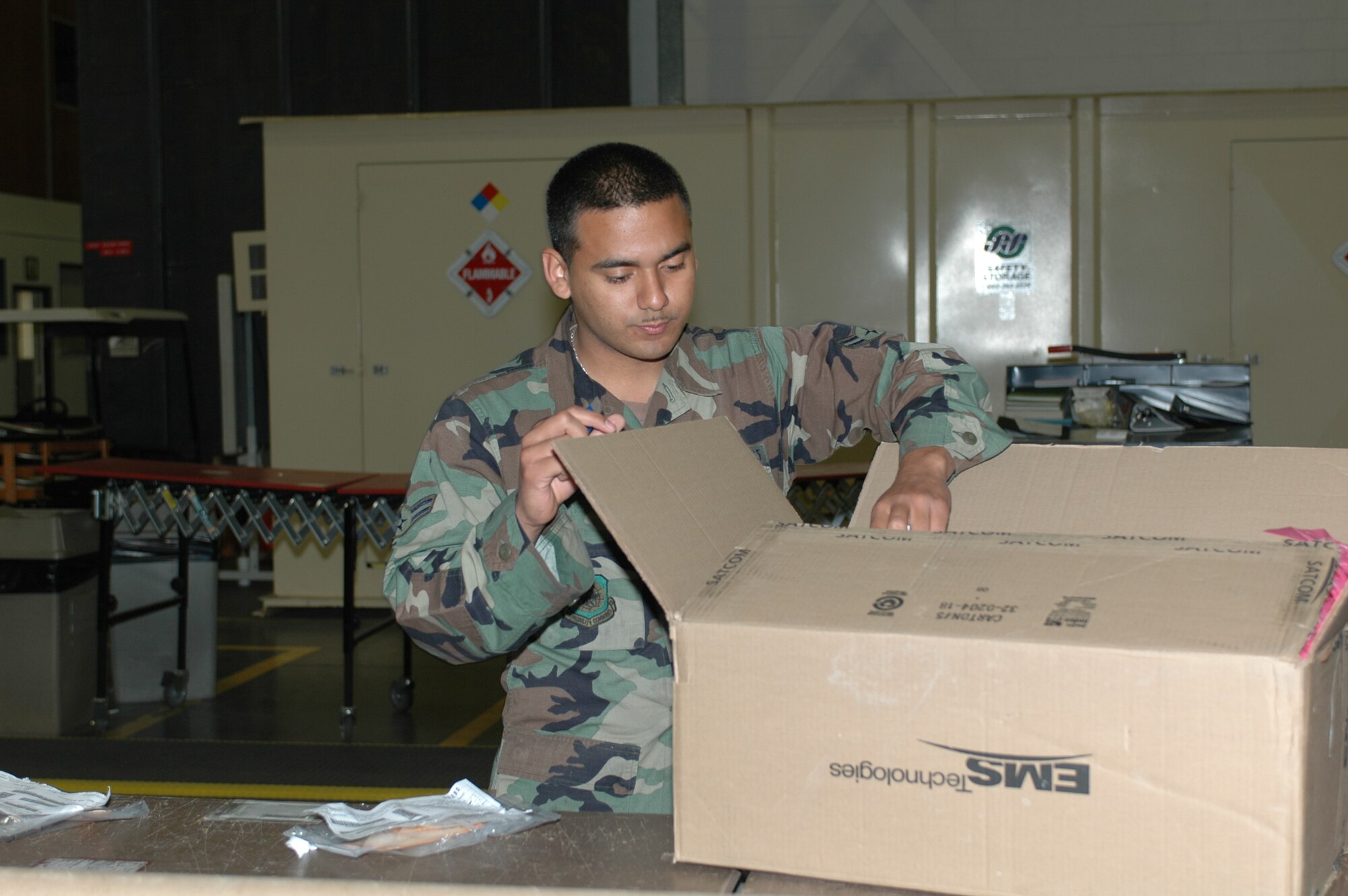 Airman 1st Class Adbel Velasquez-Villibord opens boxes of in-coming C-17 parts. (U.S. Air Force photo by Jennifer Brugman)



