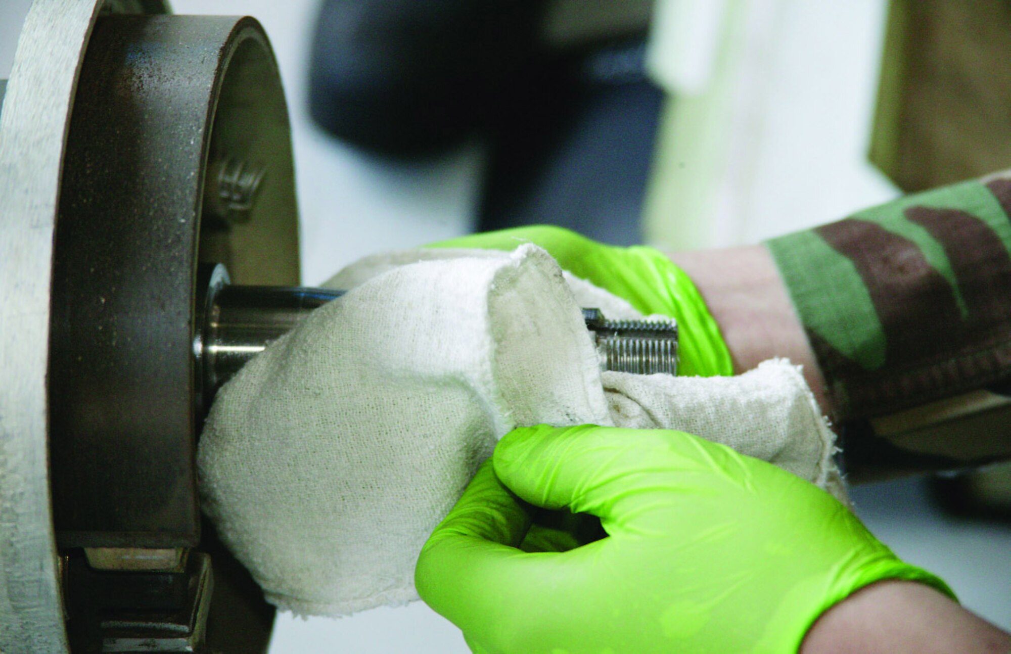 A member of the trailers section checks the trailer's spindle for wear, pitting or gouges, while making sure lubrication is at a safe level.  (U.S. Air Force Photo/Tarsha Storey)