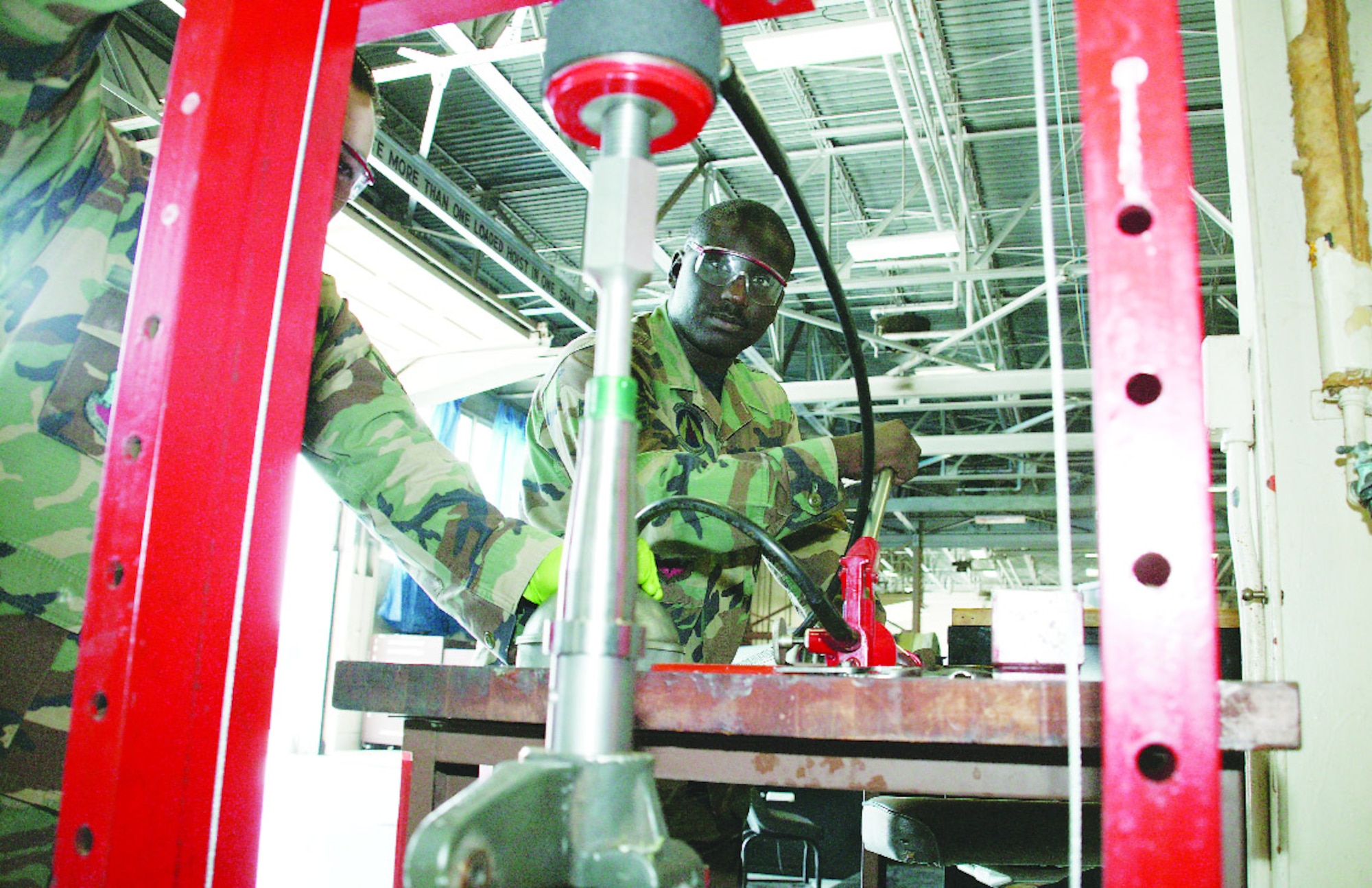 Staff Sgt. micha Brown, 20th CMS Propulsion Flight trailers section apprentice, uses a hydraulic press to remove a spindle May 25.  (U.S. Air Force Photo/Tarsha Storey)