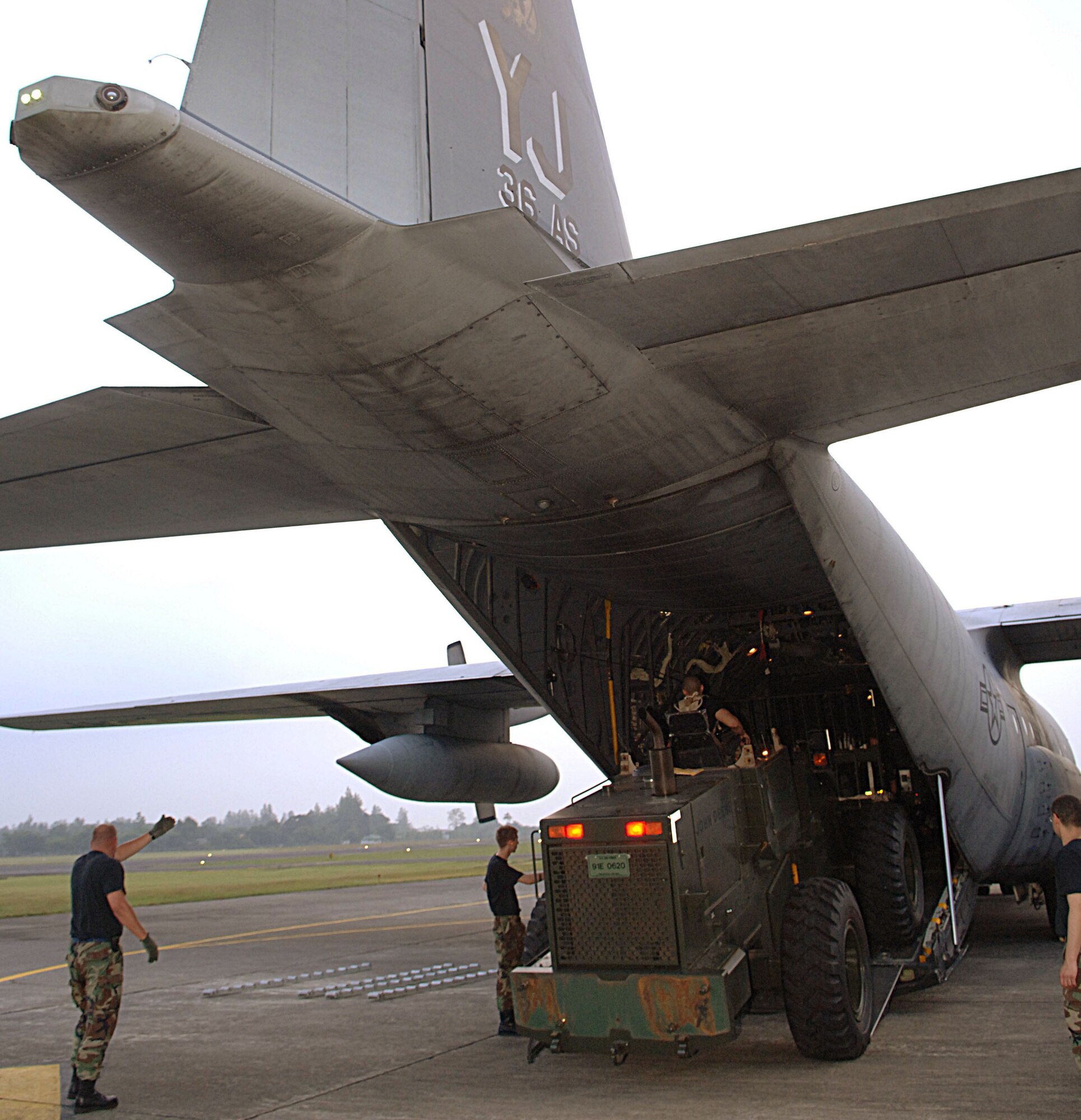 Airmen from the 36th Airlift Squadron and Combat Mobility Element at Yokota Air Base, Japan, unload supplies and equipment at Yogyakarta, Indonesia, on Thursday, June 1, 2006. The C-130 Hercules mission brought humanitarian relief aid to Indonesia, after an earthquake claimed the lives of more than 6,200 people and injured thousands more. (U.S. Air Force photo/Airman 1st Class Javier Cruz Jr.)