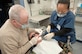Army Lt. Col. James Ross examines a patient's teeth with help from Senior Airman Nichol De Veyra, dental technician, at the 305th Medical Group dental clinic May 5.