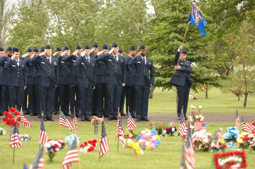 Airmen from the 5th CommunicationSquadron render salutes to fallen veterans during a Memorial Day tribute at Rosehill Memorial Park in the city of Minot May 29. (U.S. Air Force photo by Staff Sgt. Joe Laws)