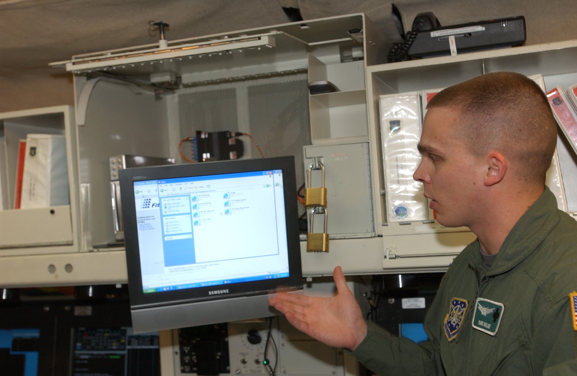 Capt. Mark Bigley, 741st Missile Squadron combat crew commander, explains how Juliet-01’s new computer with Internet access works within the launch control center May 30. The system, Netlink, allowing Internet access will undergo an initial trial phase of 60 days to collect data on the success of the new system. If the results deem positive then a blanket approval will be sought to install the same system at all 15 missile alert facilities within the 91st Space Wing. U.S. Air Force photo by Airman 1st Class Cassandra Butler)