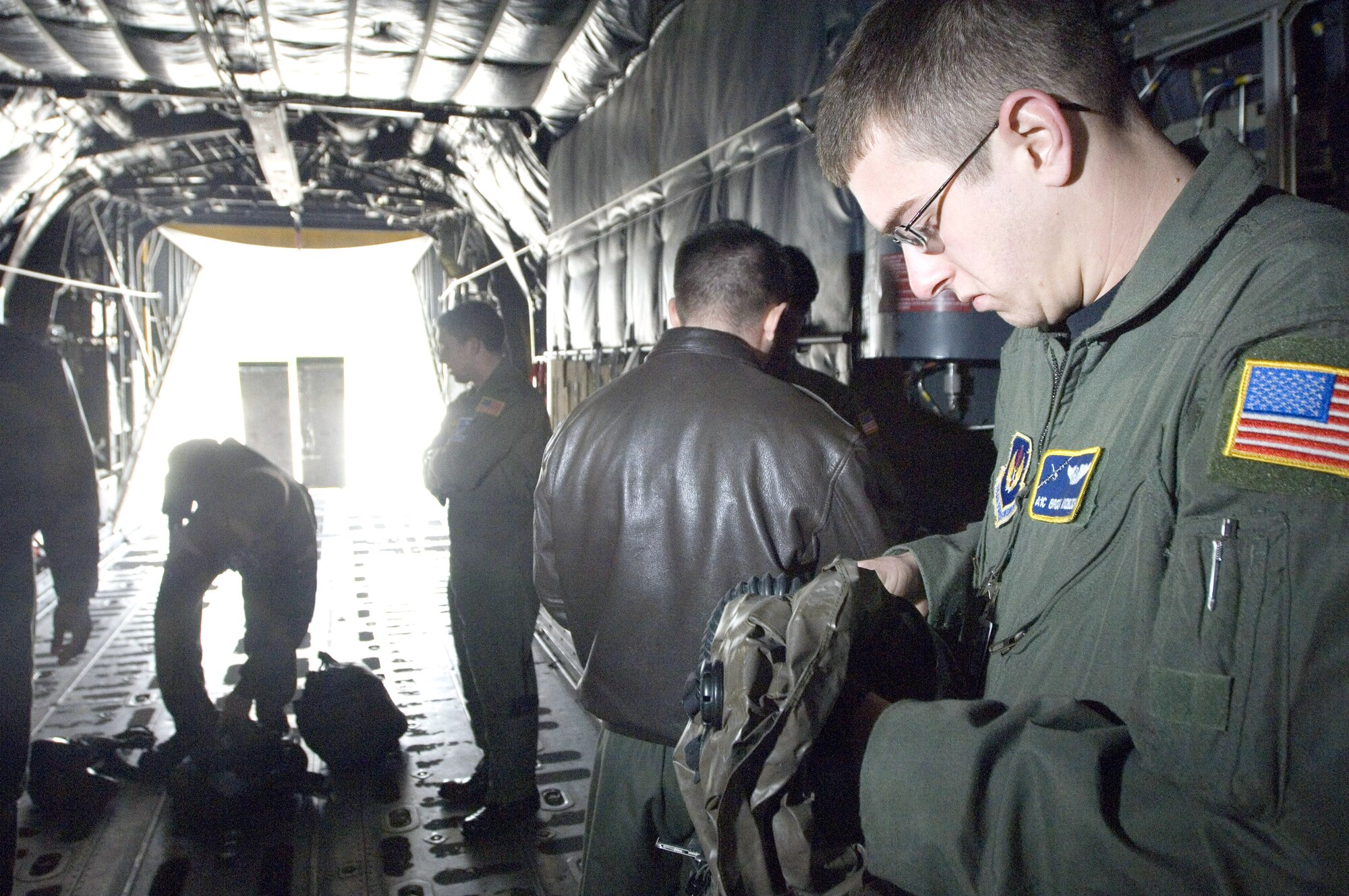 Airman 1st Class Broch Knobloch prepares to don his emergency respiratory protection system at egress training on a C-130 Hercules at Ramstein Air Base, Germany, on Thursday, June 1, 2006. Airman Knobloch is a loadmaster with the 37th Airlift Squadron at Ramstein. (U.S. Air Force photo/Master Sgt. John E. Lasky) 
