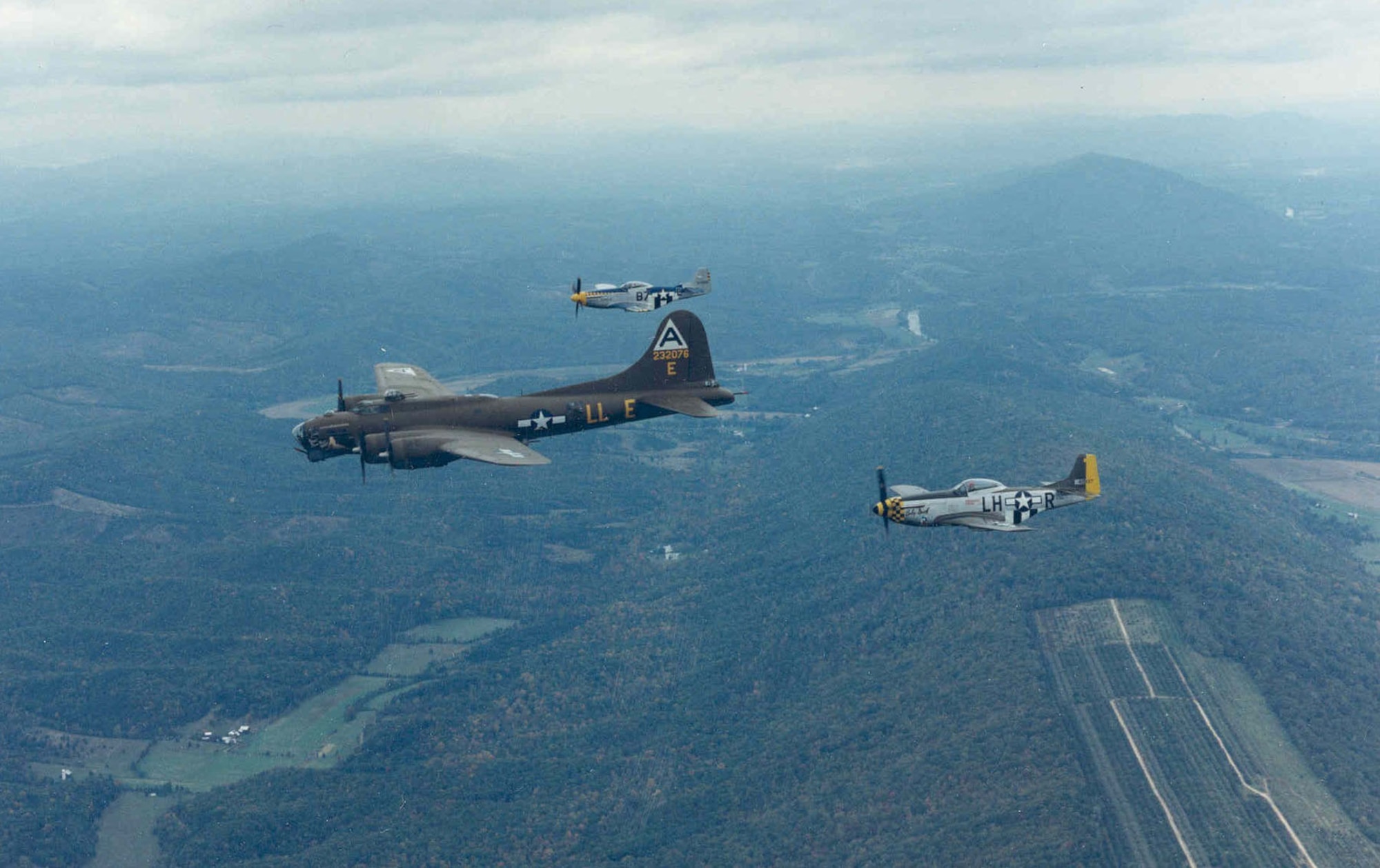 Boeing B-17G "Shoo Shoo Shoo Baby" with P-51 escort during its flight to the National Museum of the United States Air Force on Oct. 12, 1988. (U.S. Air Force photo)