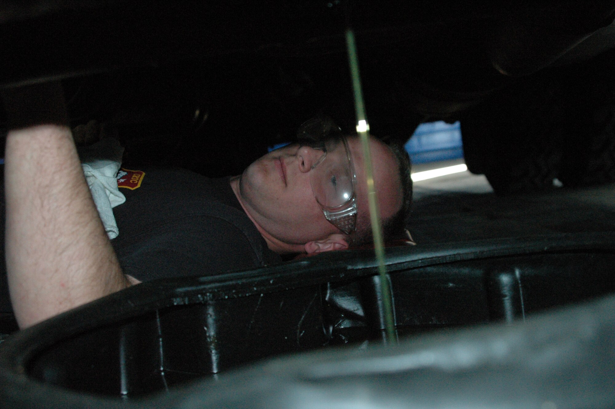 YOUNGSTOWN AIR RESERVE STATION, Ohio - Air Force Reserve Tech. Sgt. Todd Troyer, a vehicle maintenance specialist with the 910th Logistics Readiness Squadron here, conducts an oil change on a de-icer truck as part of the regular maintenance program for the vehicle.  U.S. Air Force photo/Master Sgt. Bryan Ripple