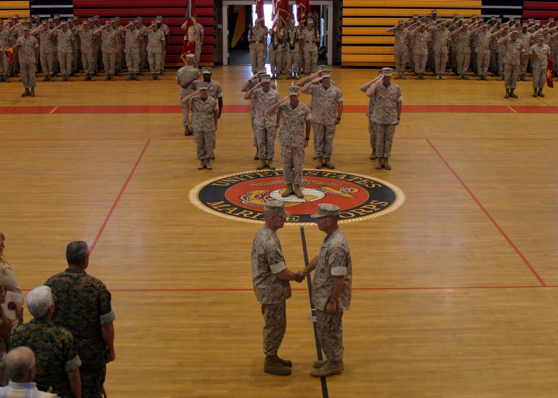 Col. Douglas Stilwell shakes hands with Col. Kenneth F. McKenzie during the 22nd Marine Expeditionary Unit's change of command ceremony held in Goettge Memorial Field House June 2, 2006.  Col. McKenzie relinquished command to Col. Douglas Stilwell.