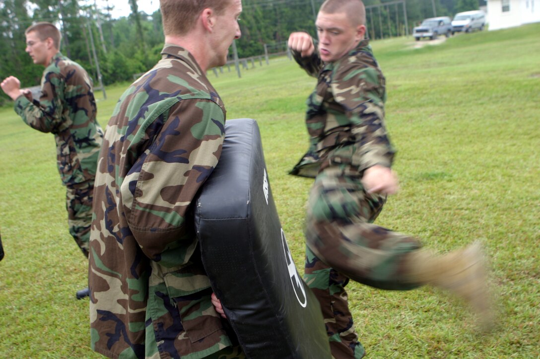 MARINE CORPS BASE CAMP LEJEUNE, N.C. (June 5, 2006) ? A Naval Reserve Officer Training Corps student kicks the bag held by another student here June 5. A select few Naval Reserve Officer Training Corps college students, they will spend sometime in the swamp-lands of humid North Carolina getting a taste of what it?s like to be a Marine and are demonstrated Marine Corps Martial Arts by the Marines of 2nd Marine Logistics Group.