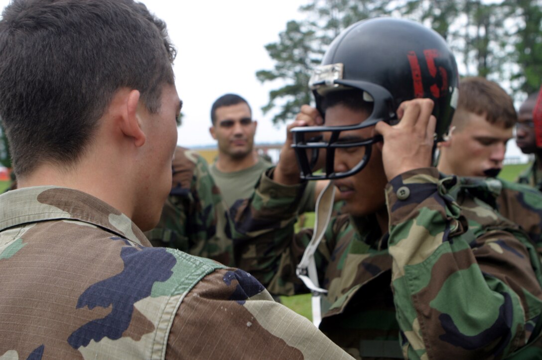 MARINE CORPS BASE CAMP LEJEUNE, N.C. (June 5, 2006) ? A Naval Reserve Officer Training Corps student is helped out putting on gear by another student here June 5. A select few Naval Reserve Officer Training Corps college students, they will spend sometime in the swamp-lands of humid North Carolina getting a taste of what it?s like to be a Marine and are demonstrated Marine Corps Martial Arts by the Marines of 2nd Marine Logistics Group.