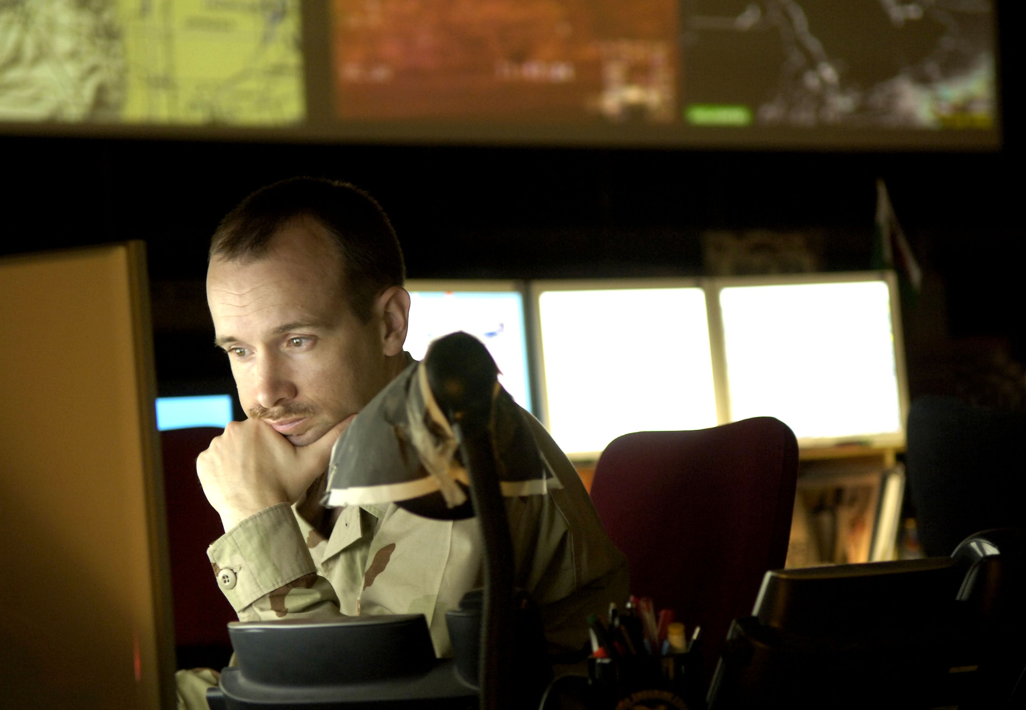 Maj. David Ahrens coordinates aircraft operations in the U.S. Central Command area of responsibility on Thursday, June 1, 2006. Major Ahrens is the senior intelligence duty officer at the Combined Air Operations Center in Southwest Asia. (U.S. Air Force photo/Senior Airman Brian Ferguson) 
