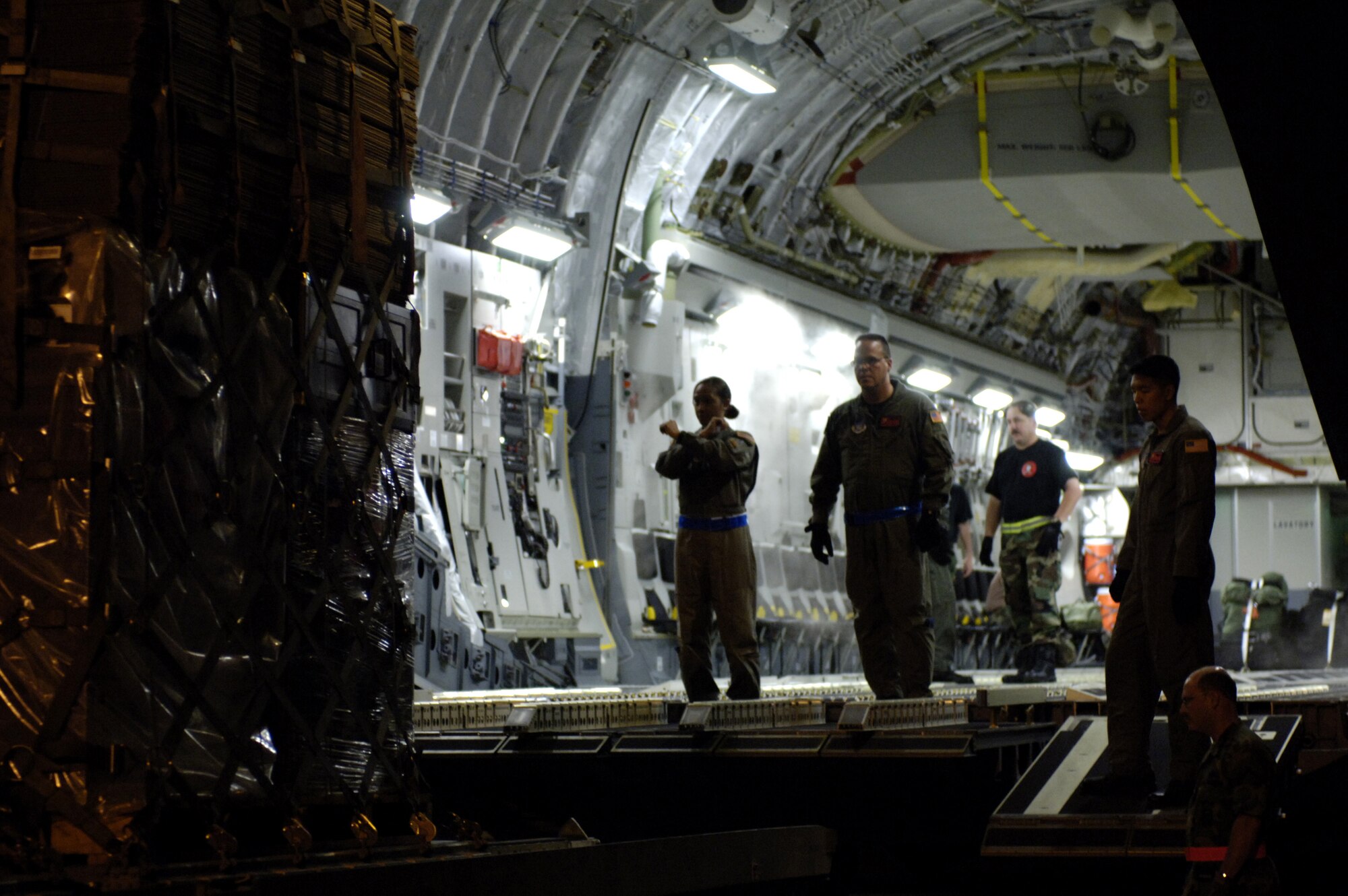 HICKAM AFB, Hawaii, (AFPN) - C-17 loadmasters marshal a pallet aboard a C-17 Globemaster III at Royal Australian Air Force Base Townsville, Australia on May 28, 2006. (U.S. Air Force photo by Tech Sgt. Shane A. Cuomo)