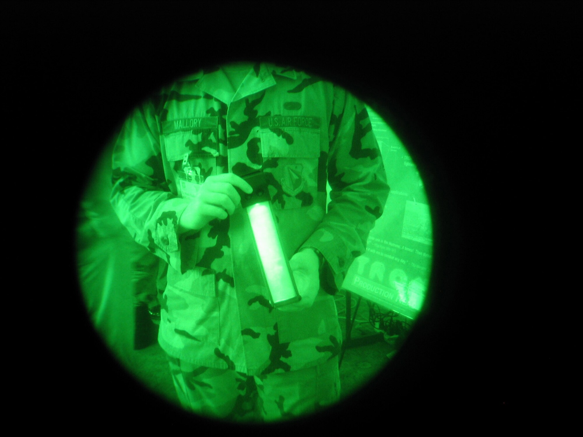 1st Lt. Mark Mallory, an engineer at the Air Force Research Lab at Wright-Patterson Air Force Base, Ohio, demonstrates the Target Recognition Operator Notification system. TRON is a lighting device that can only be seen through night vision goggles. AFRL’s display was just one of 19 during Technology Days here. 