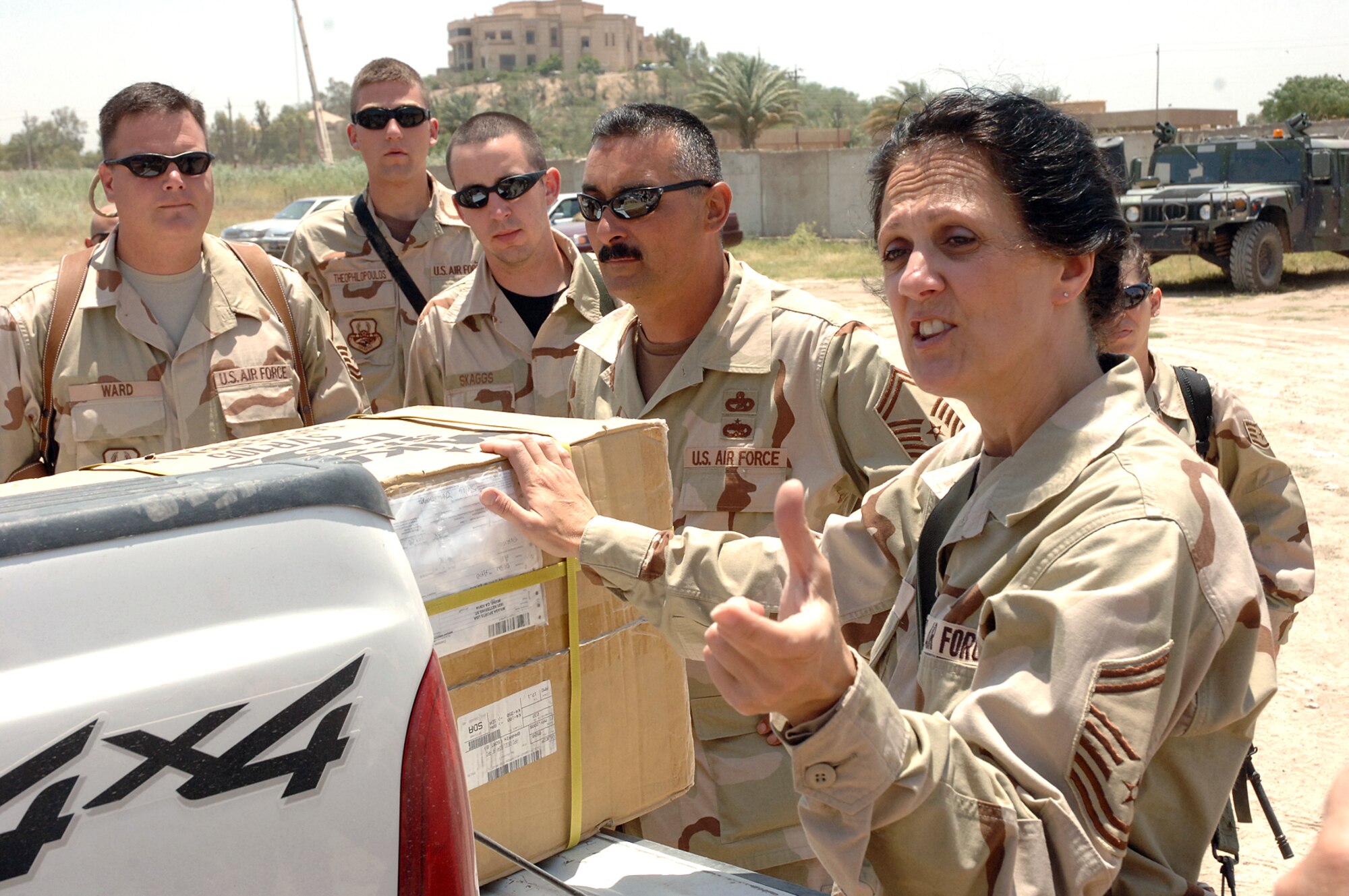 Senior Master Sgt. Jennifer Taglieri briefs the plan of the day to other Airmen from Sather Air Base, Iraq, before entering the Army's Civil Military Operations Center at the Radwinya Palace Complex. Three days a week, Airmen from Sather volunteer at the facility, providing limited medical care and other needs to local Iraqi families. Sergeant Taglieri is deployed from Lackland Air Force Base, Texas. (U.S. Air Force photo/Staff Sgt. Bryan Bouchard)