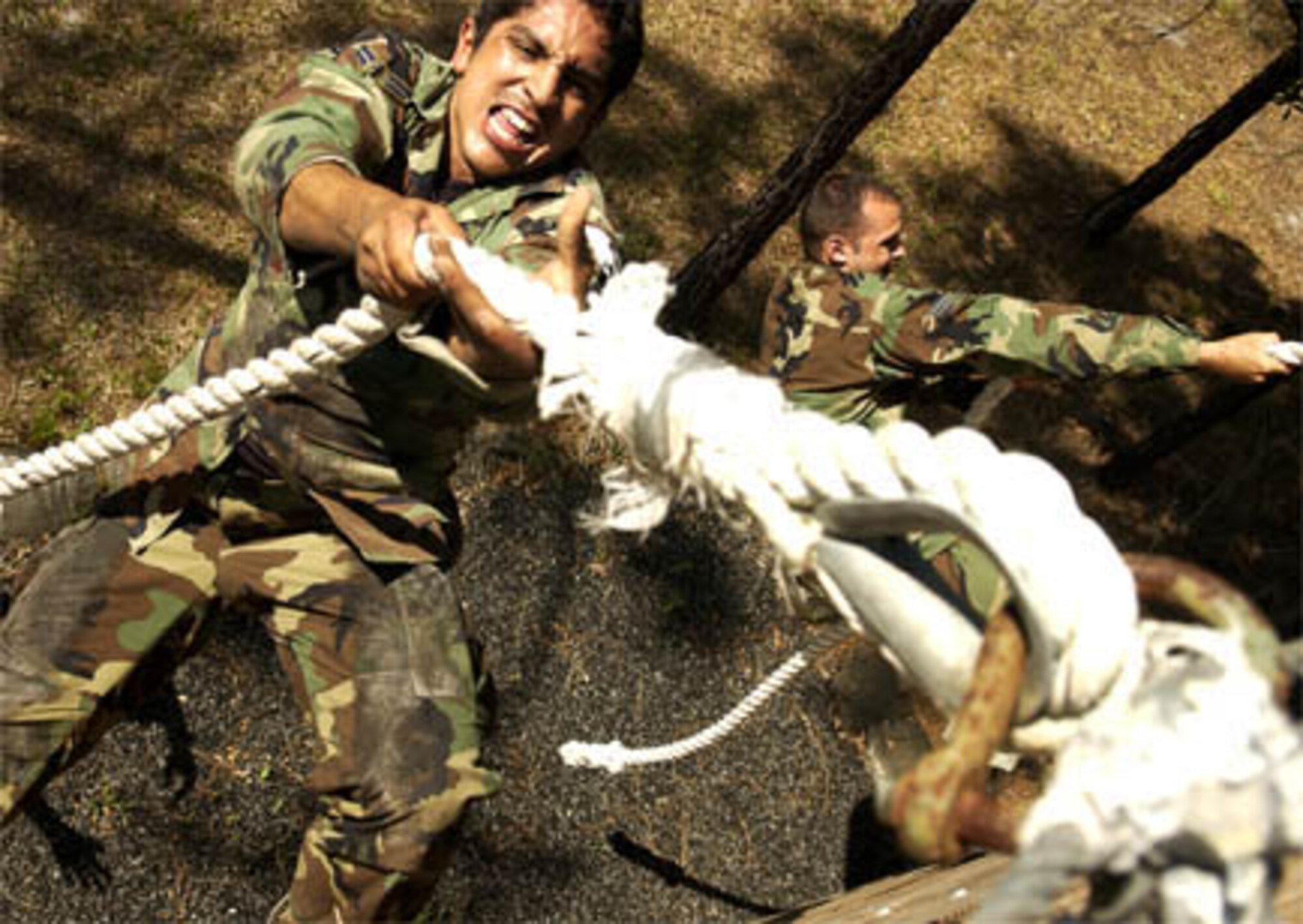 Air Force Airman First Class Mike Macias, 15th Air Support Squadron Fort Stewart GA, climes a wall at Dragon Challenge Avon Park, Fl., May 21, 2006.   Dragon Challenge is a 18th Air Support Operations Group competition the challenges battlefield Airman both mentally and physically and helps prepare them and test their skills for the stresses of combat.   (US Air Force Photo by Tech Sgt. Jeromy K. Cross)