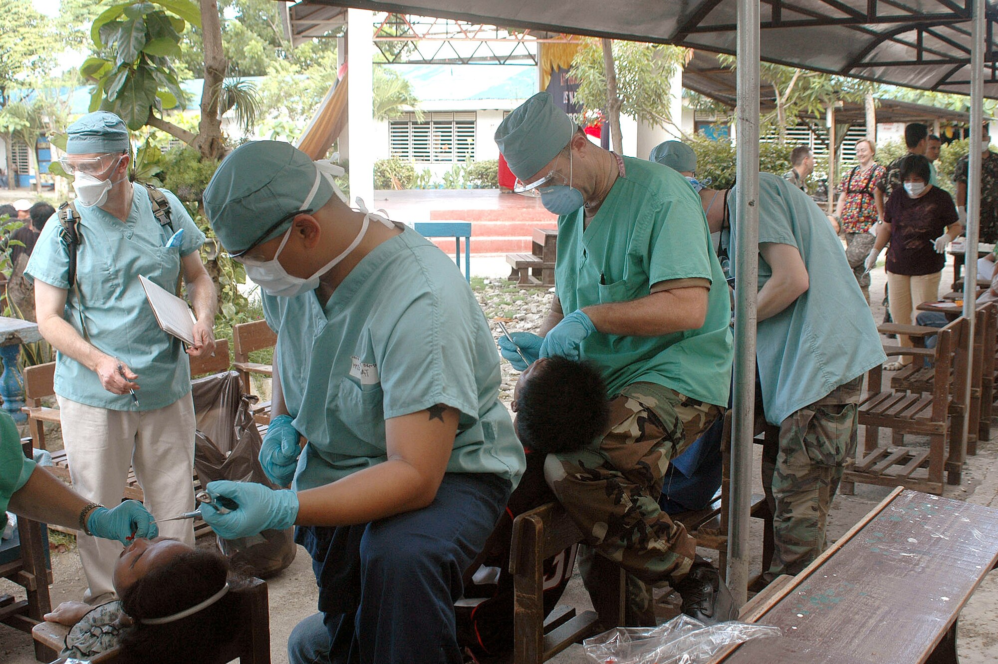 Air Force and Navy dentists from the U.S. Navy hospital ship, USNS Mercy, extract teeth during a medical civic action program that helped more than 1,000 people in Zamboanga City, Philippines on Sunday, May 28, 2006. The doctors extracted more than 400 teeth from 221 people in six hours. The crew is conducting humanitarian and civic assistance in South and Southeast Asia and the Pacific Islands. (U.S. Navy photo/Chief Photographer's Mate Don Bray)