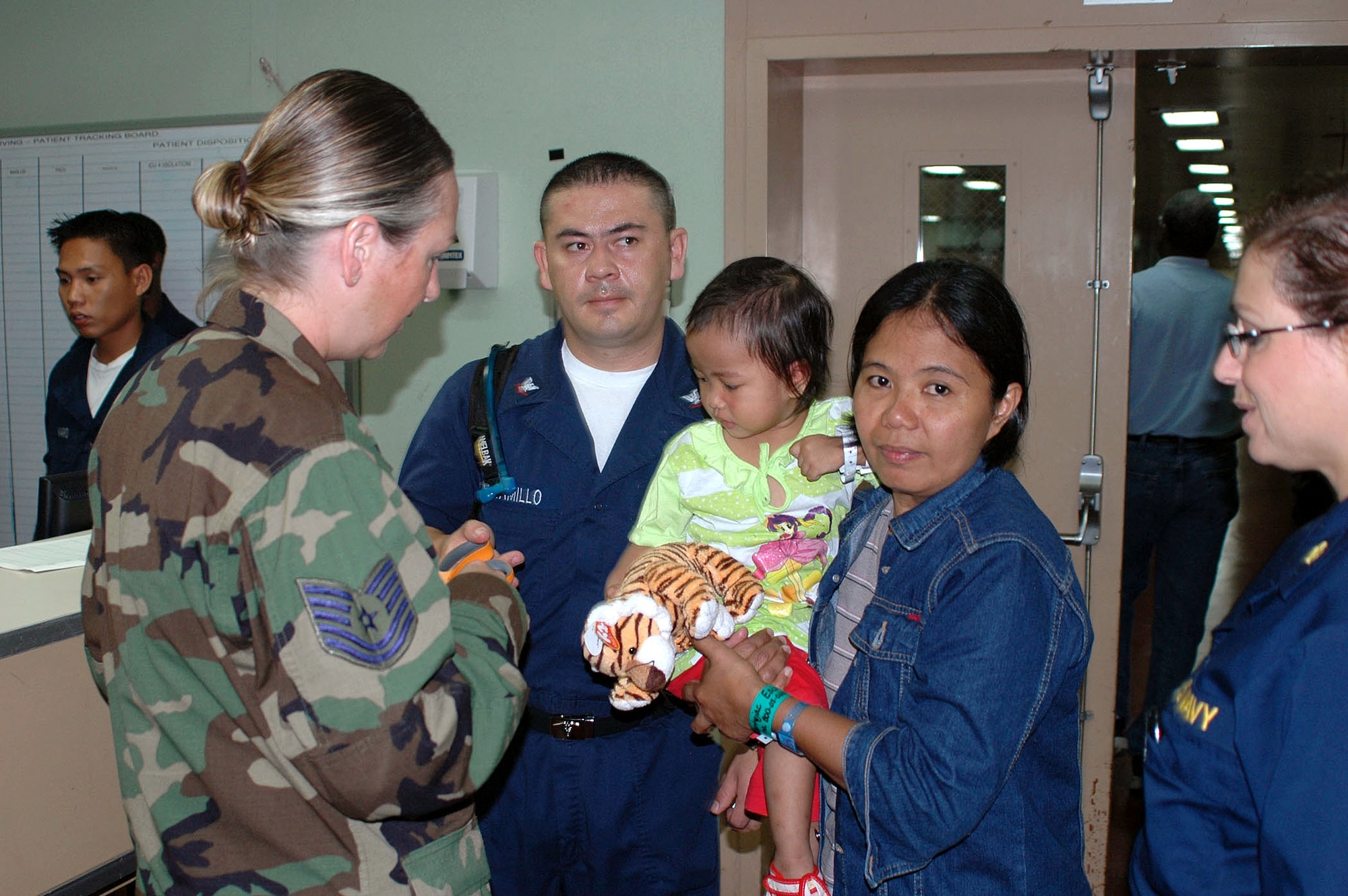Tech. Sgt. Carla Lefrancois and Hospital Corpsman 3rd Class Javier Jaramillo admit a patient to the casualty receiving area aboard the U.S. Navy hospital ship, USNS Mercy, while anchored off the city of Zamboanga, Philippines on Friday, May 26, 2006. The crew is conducting humanitarian and civic assistance in South and Southeast Asia and the Pacific Islands. Sergeant Lefrancois is one of several Air Force medical professionals on the ship. (U.S. Navy photo/Chief Photographer's Mate Don Bray) 