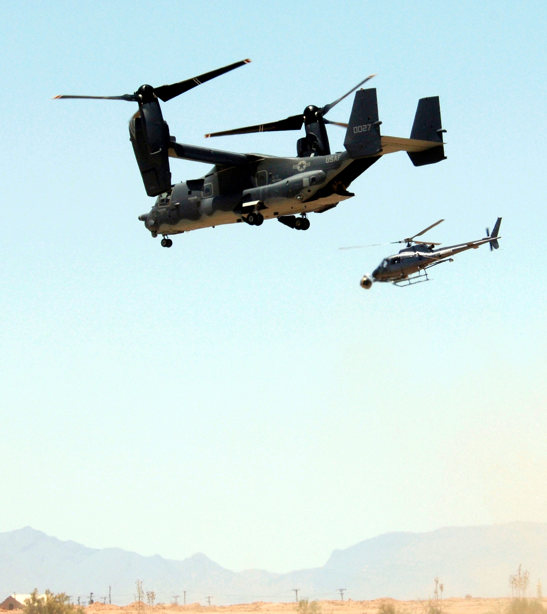 A camera onboard a helicopter films an Air Force CV-22 Osprey as it takes off from Holloman Air Force Base, N.M., on Friday, May 26, 2006. The Osprey and its crew are taking part in the filming of the movie, "Transformers." (U.S. Air Force photo/Airman 1st Class Russell Scalf) 
