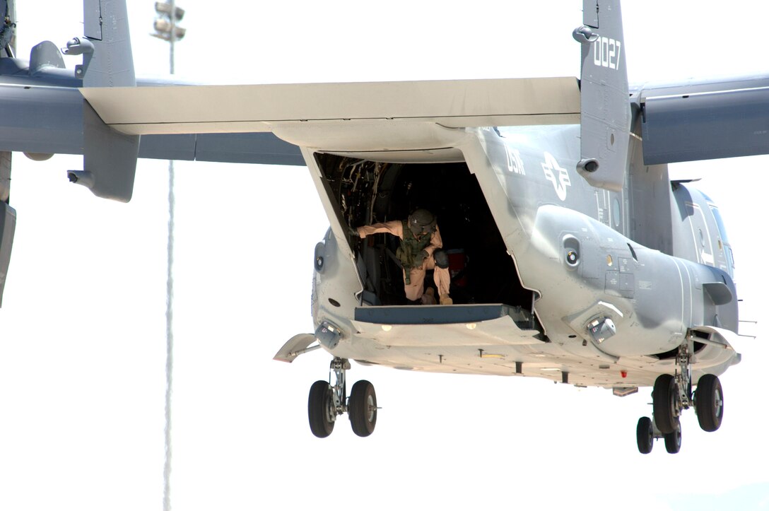 A crewmember of an Air Force CV-22 Osprey prepares to land at Holloman Air Force Base, N.M., on May 26, 2006. The Osprey and its crew are taking part in the filming of the movie, "Transformers." (U.S. Air Force photo/Airman 1st Class Russell Scalf) 