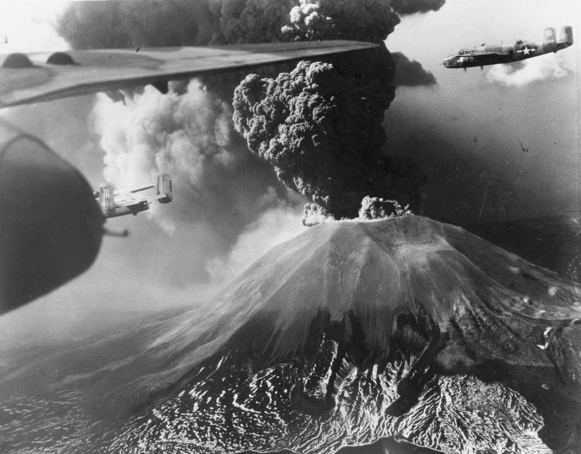 North American B-25s fly past Mount Vesuvius during an eruption. (U.S. Air Force photo)