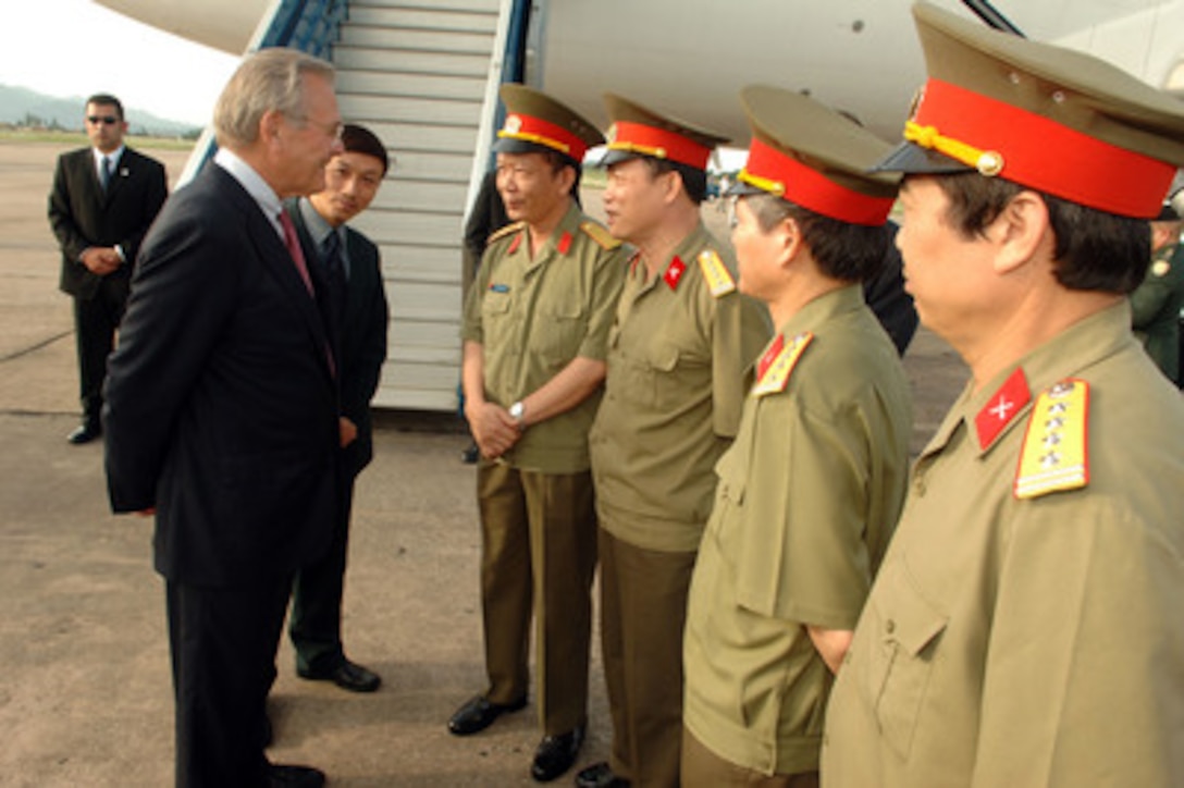 Secretary of Defense Donald H. Rumsfeld speaks with Maj. Gen. Phan Thanh Lan, Director External Relations Department, after arriving at Noi Bai Airport in Hanoi, Vietnam, on June 4, 2006. Rumsfeld is in Hanoi to meet with Vietnamese leaders and to visit a U.S. team investigating the whereabouts of the nearly 2,000 American servicemembers still unaccounted for from the Vietnam War. 