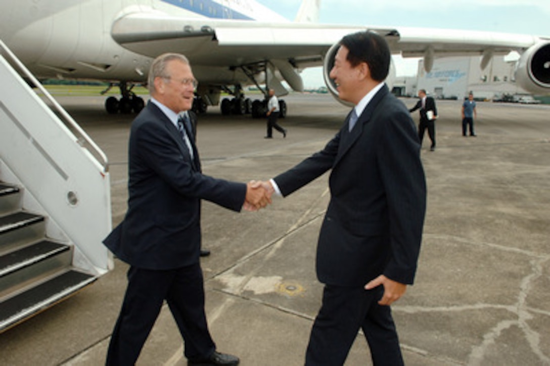 Singapore's Minister of Defense Teo Chee Hean (right) greets Secretary of Defense Donald H. Rumsfeld as he arrives at Paya Lebar Air Base, Singapore, on June 2, 2006. Rumsfeld is in Singapore to meet with regional allies and attend the fifth annual International Institute for Strategic Studies Asia Security Conference known as the Shangri-La Dialogue. 