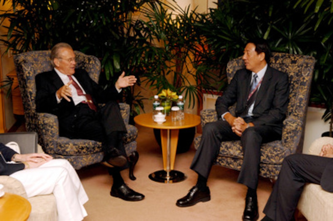 Secretary of Defense Donald H. Rumsfeld talks with Singapore's Minister of Defense Teo Chee Hean at the beginning of a bilateral meeting at the Shangri-La Hotel in Singapore on June 3, 2006. Rumsfeld is in Singapore to meet with regional allies and attend the fifth annual International Institute for Strategic Studies Asia Security Conference known as the Shangri-La Dialogue. 