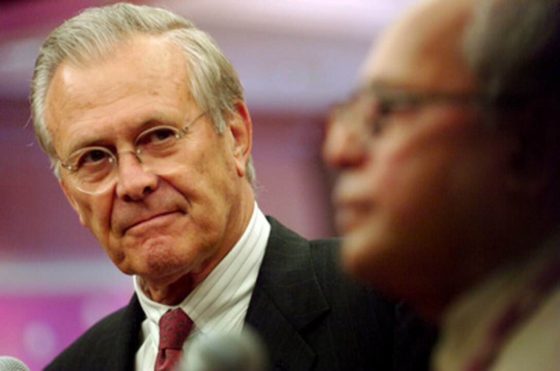 Secretary of Defense Donald H. Rumsfeld listens as India's Minister of Defense Pranab Mukherjee talks to reporters during a media availability at the Shangri-La Hotel in Singapore on June 3, 2006. Rumsfeld and Mukherjee are in Singapore to meet with regional allies and attend the fifth annual International Institute for Strategic Studies Asia Security Conference known as the Shangri- La Dialogue. 