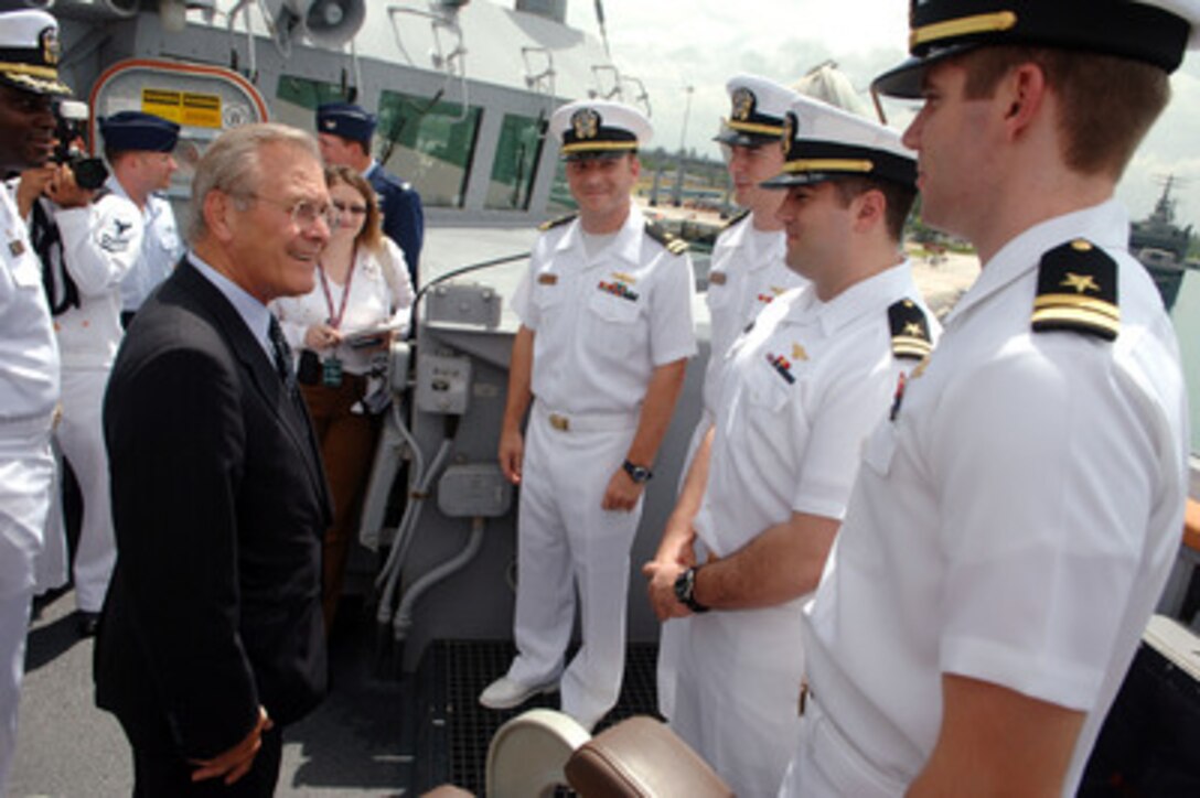 Secretary of Defense Donald H. Rumsfeld talks with four new lieutenants after presiding over their promotion ceremony on the bridge wing of the USS McCampbell (DDG 85) in port in Singapore on June 4, 2006. Rumsfeld is in Singapore to meet with regional allies and attend the fifth annual International Institute for Strategic Studies Asia Security Conference known as the Shangri-La Dialogue. The McCampbell, an Arliegh Burke class destroyer, is making a port visit to Singapore. 
