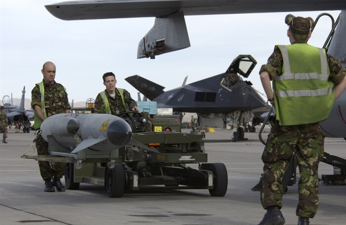 Sgt. Brian Scott (left), Cpl. Dave Parkinson (right), and Senior Aircraftsman Gary Shackleton (middle), weapons technicians from the IX Bomb Squadron, Royal Air Force, United Kingdom, load an outboard store to a GR-4 Tornado. The Royal Air Force is at Nellis to take part in Red Flag, an exercise that tests aircrew war-fighting skills in real-time combat situations. Red Flag involves more than 200 aircraft ranging from B-52 Stratofortresses to F-16 Fighting Falcons. The exercise will run through Feb. 18.
