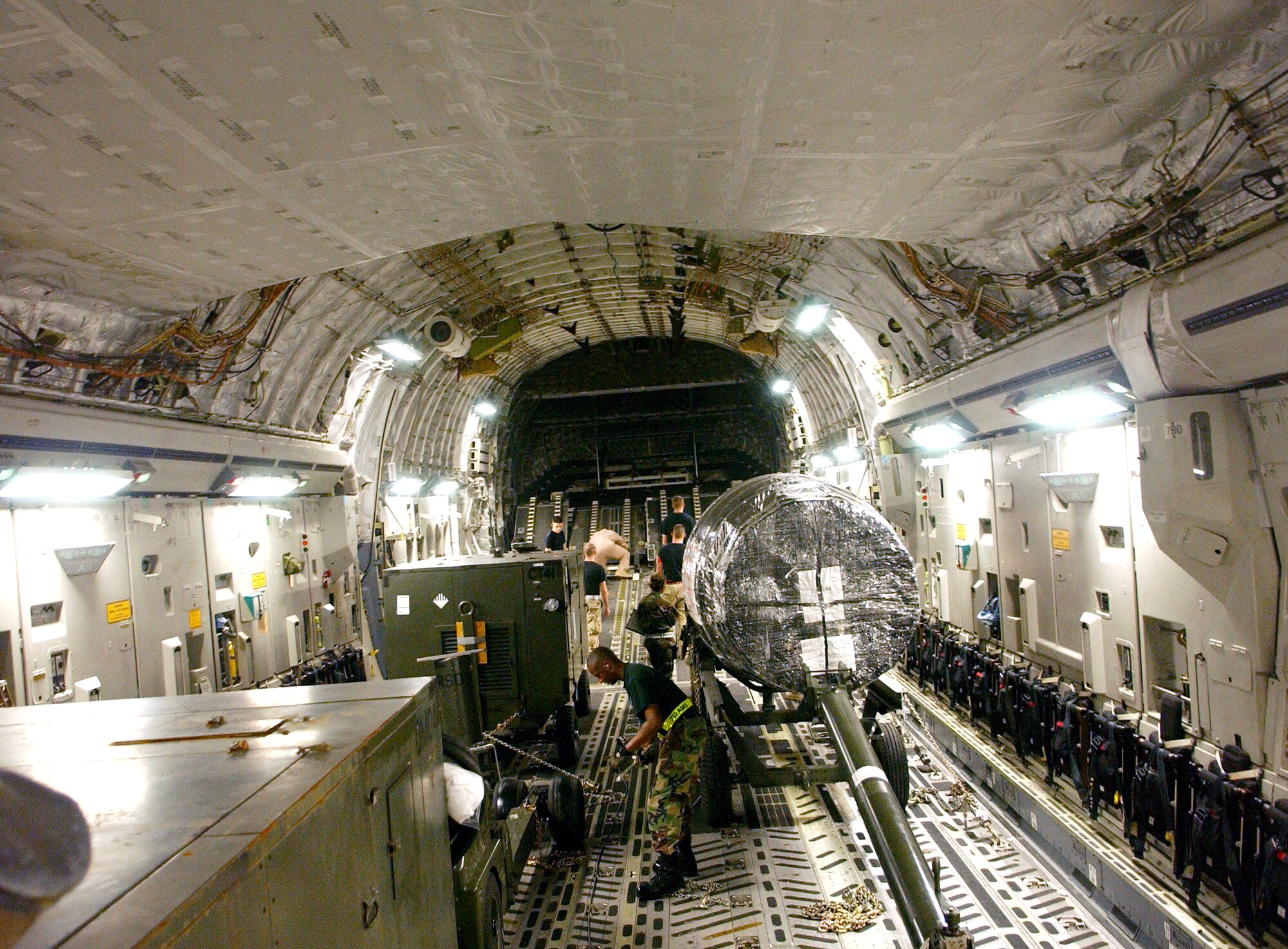 Airmen deployed to the 40th Air Expeditionary Group prepare cargo on a C-17 Globemaster III on Monday, June 5, 2006, in support of Operation Enduring Freedom. (U.S. Air Force photo/Staff Sgt. Patrick Mitchell) 
