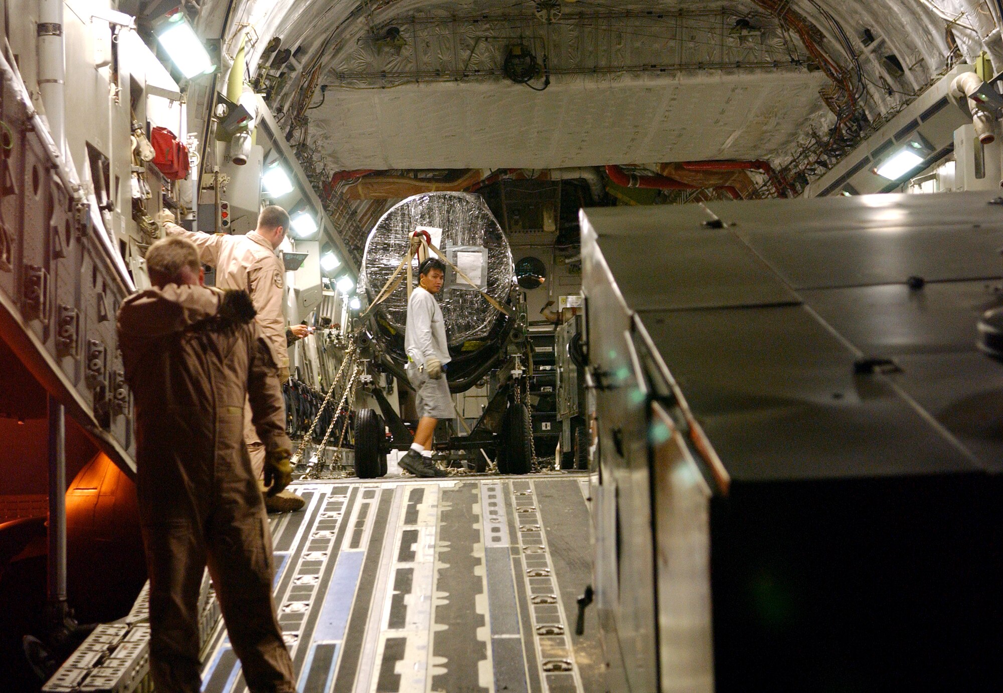 Airmen deployed to the 40th Air Expeditionary Group prepare cargo on a C-17 Globemaster III on Monday, June 5, 2006, in support of Operation Enduring Freedom. (U.S. Air Force photo/Staff Sgt. Patrick Mitchell) 
