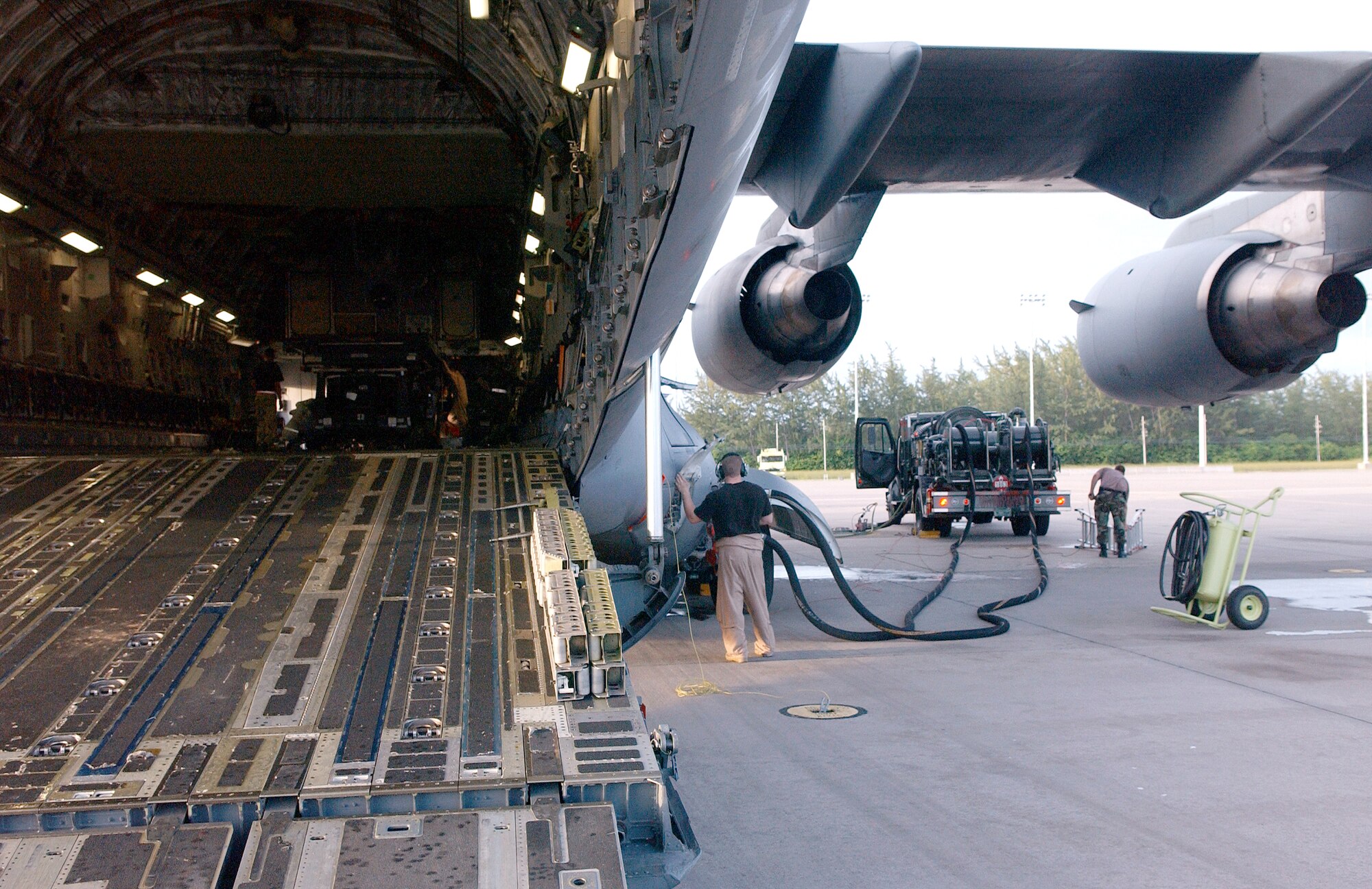 Airmen deployed to the 40th Air Expeditionary Group prepare cargo and fuel a C-17 Globemaster III on Monday, June 5, 2006, in support of Operation Enduring Freedom. (U.S. Air Force photo/Staff Sgt. Patrick Mitchell) 

                                                 