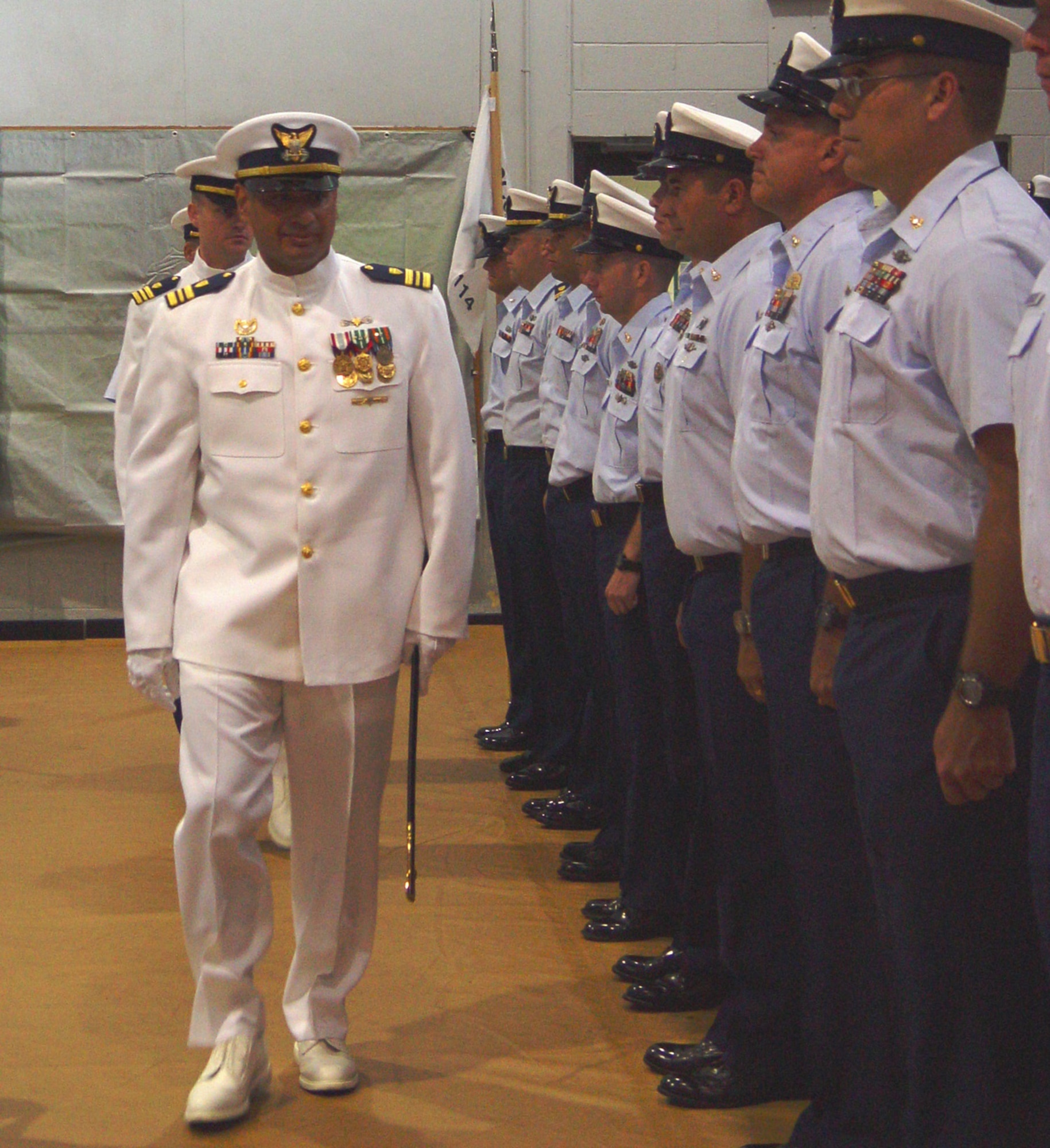 Lt. Cmdr. Carlos Mercado, outgoing commanding officer of Maritime Safety and Security Team 911-14, makes a final review of his unit.  Lt. Cmdr. Jonathan Theel, originally from Denver, Colorado, is the new commanding officer of the unit (Air Force photo by Lisa Macias).