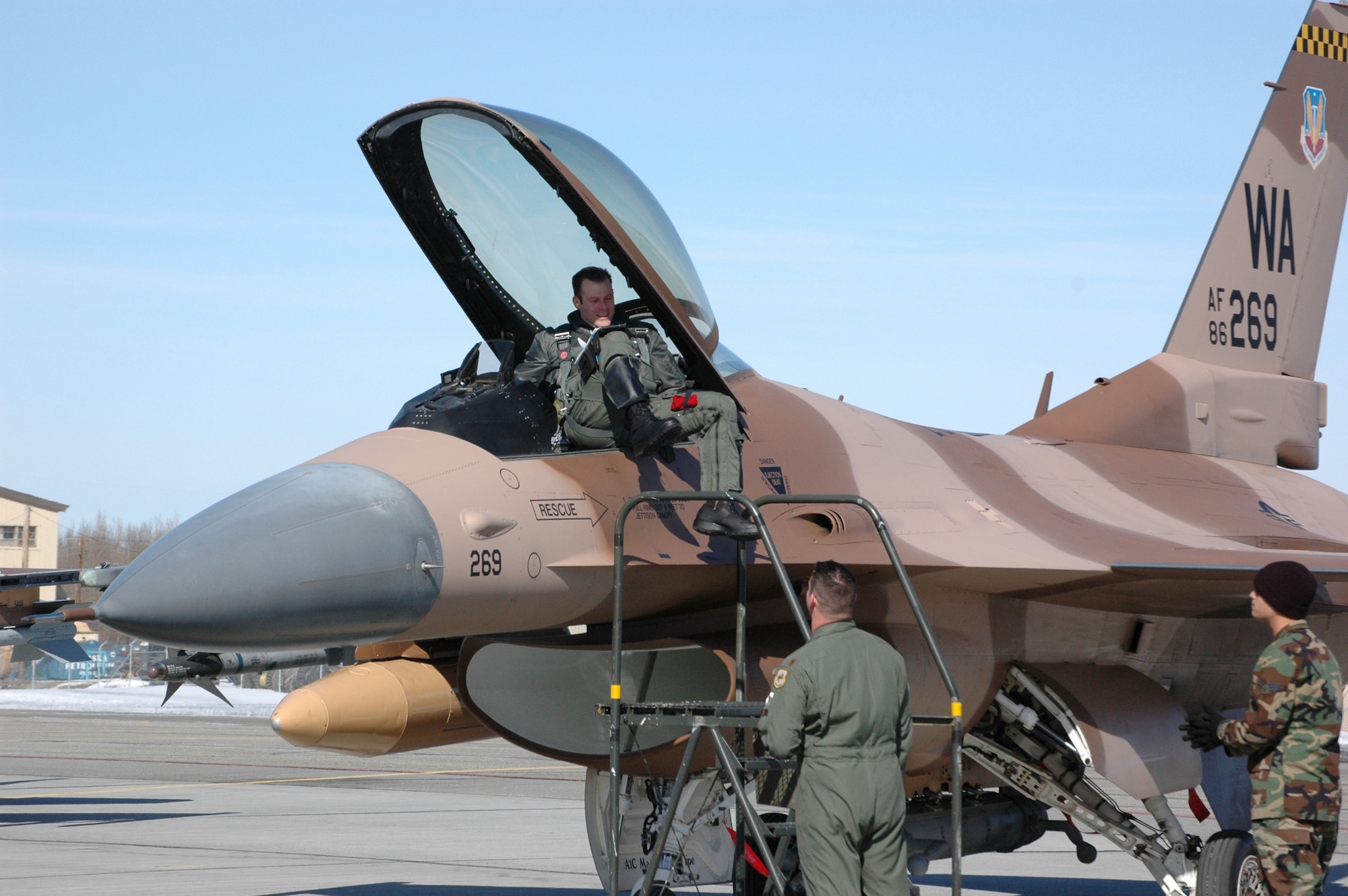 Maj. Sean Routier, 64th Aggressor Squadron pilot, climbs down from his F-16 Fighting Falcon April 17, 2006 at Eielson AFB, Alaska. The Aggressors will be participating in the first-ever Red Flag - Alaska exercise, which begins April 24 and continues for two weeks.