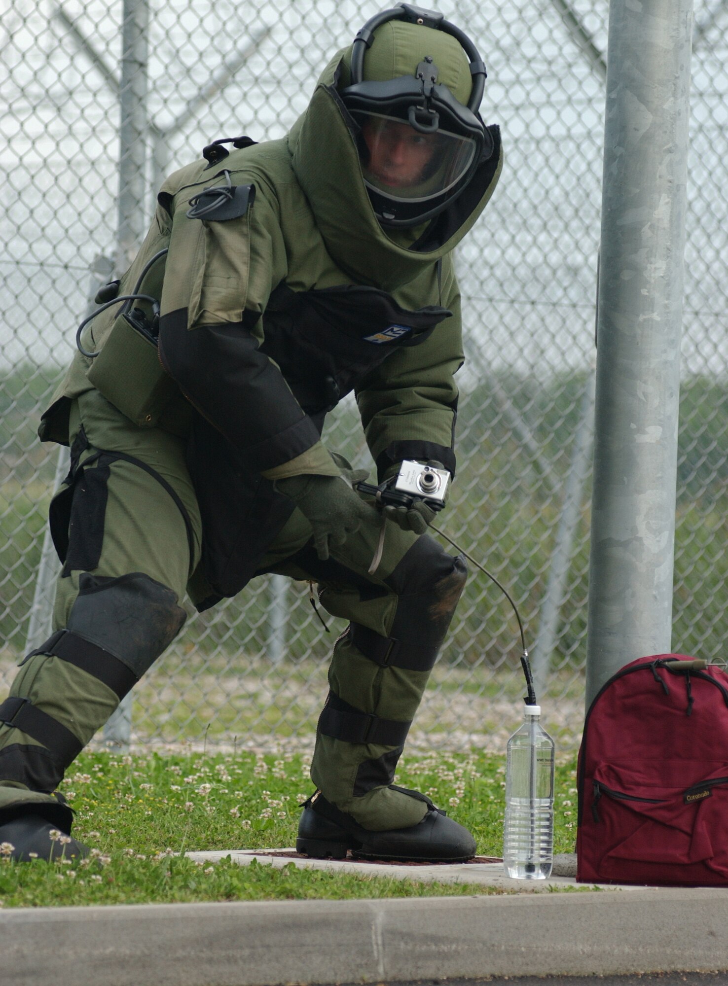 Staff Sgt. Justin Surran analyzes a suspicious package at Aviano Air Base, Italy, on Tuesday, June 6, 2006, during a Local Salty Nation training exercise. The heavy-duty Kevlar suit weighs 70 pounds and is used to protect explosive ordnance disposal troops. Sergeant Surran is assigned to the 31st Civil Engineer Squadron. (U.S. Air Force photo/Airman 1st Class Nathan Doza)