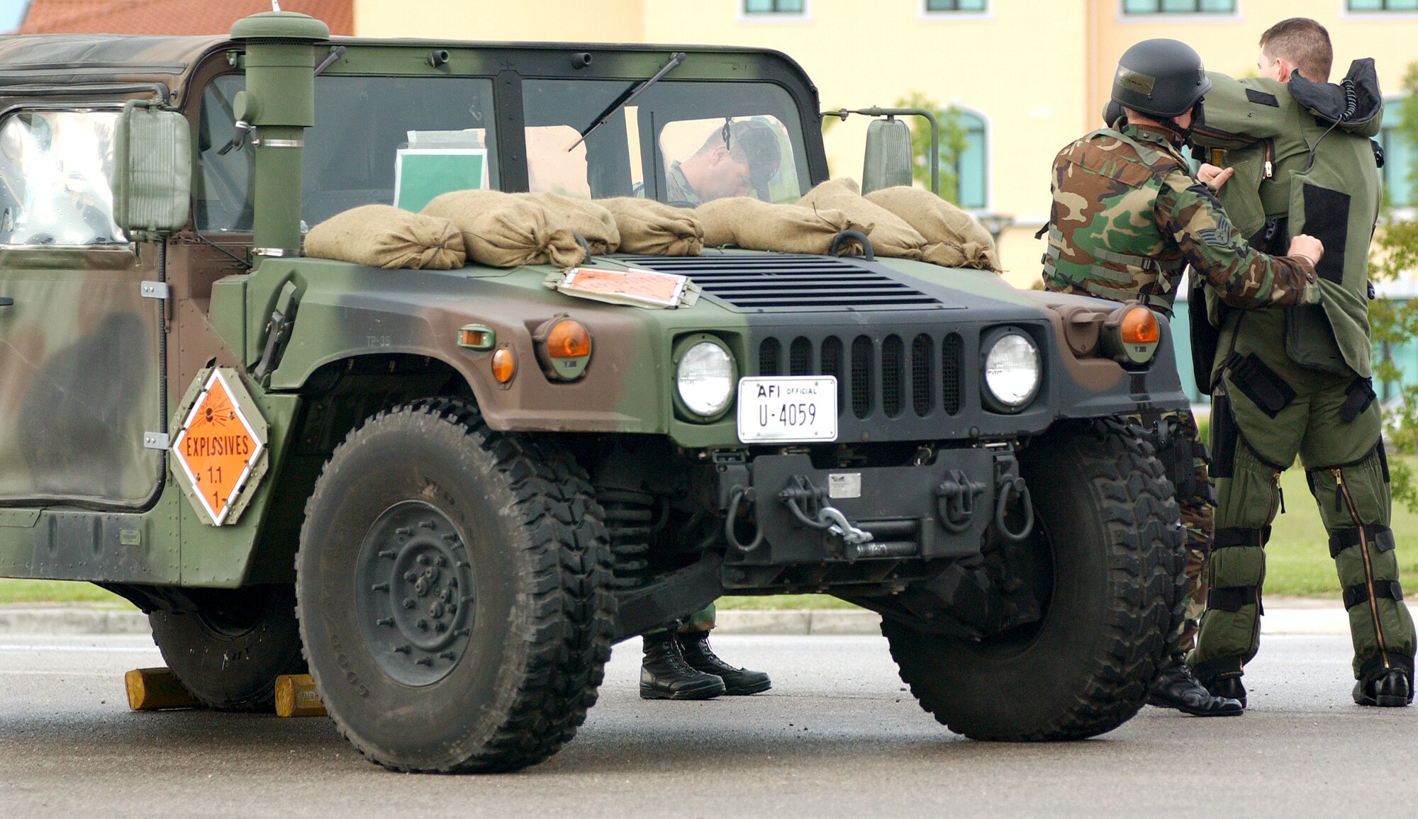 Staff Sgt. Clayton Tiemen helps Staff Sgt. Justin Surran gear up in a bomb suit at Aviano Air Base, Italy, on Tuesday, June 6, 2006, during a Local Salty Nation training exercise. The heavy-duty Kevlar suit weighs 70 pounds and is used to protect explosive ordnance disposal troops. The NCOs are assigned to the 31st Civil Engineer Squadron. (U.S. Air Force photo/Airman 1st Class Nathan Doza)
