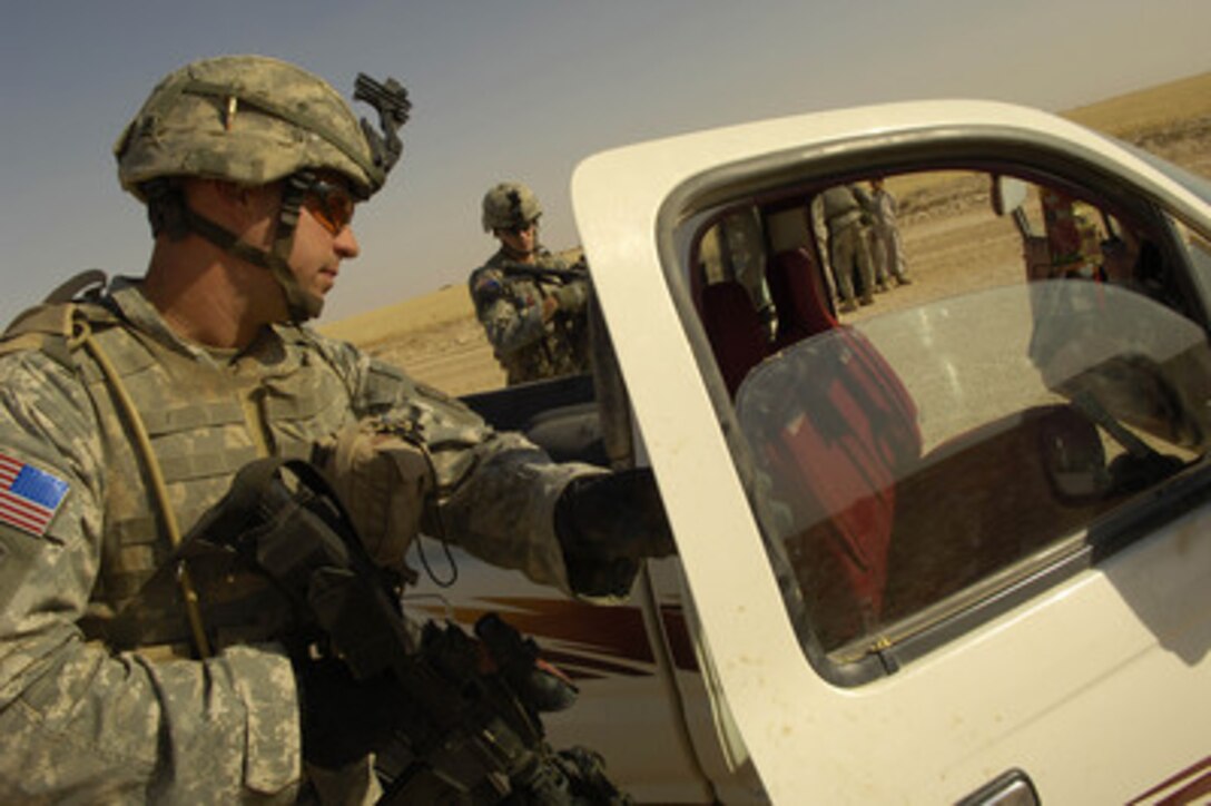 Army Spc. Alexander Jordan searches a truck during an aerial traffic control point mission near Tall Afar, Iraq, on June 5, 2006. Jordan is from Bravo Company, 4th Battalion, 23rd Infantry Regiment, 172nd Stryker Brigade Combat Team. 