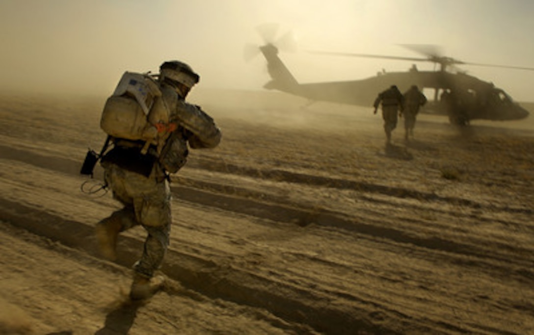 U.S. Army soldiers run towards a UH-60 Black Hawk helicopter as they are extracted after completing an aerial traffic control point mission near Tall Afar, Iraq, on June 5, 2006. The soldiers are from Bravo Company, 4th Battalion, 23rd Infantry Regiment, 172nd Stryker Brigade Combat Team and the Black Hawk aircrew is from Bravo Company, 1st Battalion, 207th Aviation, Alaska National Guard. 